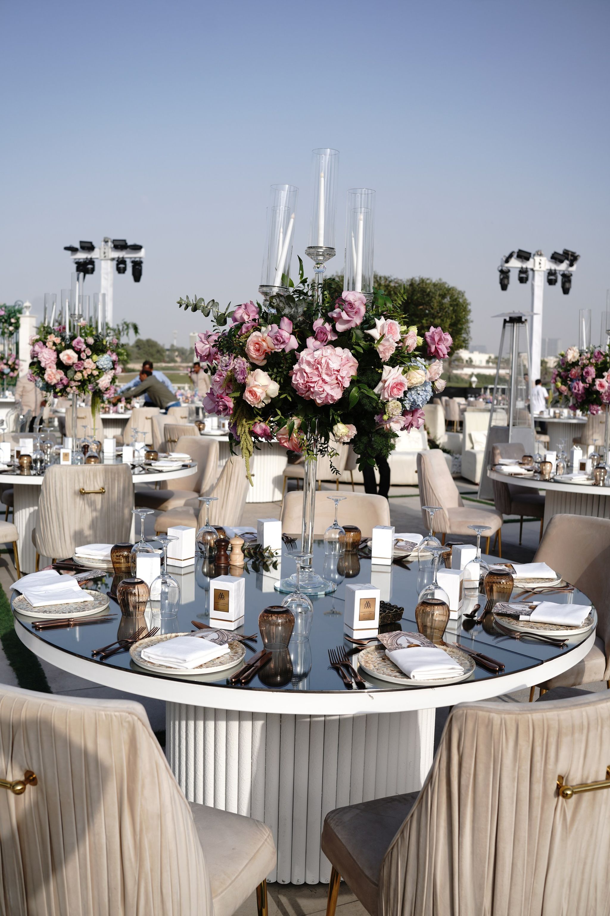 Mirrored dining table with a tall candelabrum of pink roses at Four Seasons Resort Dubai at Jumeirah Beach