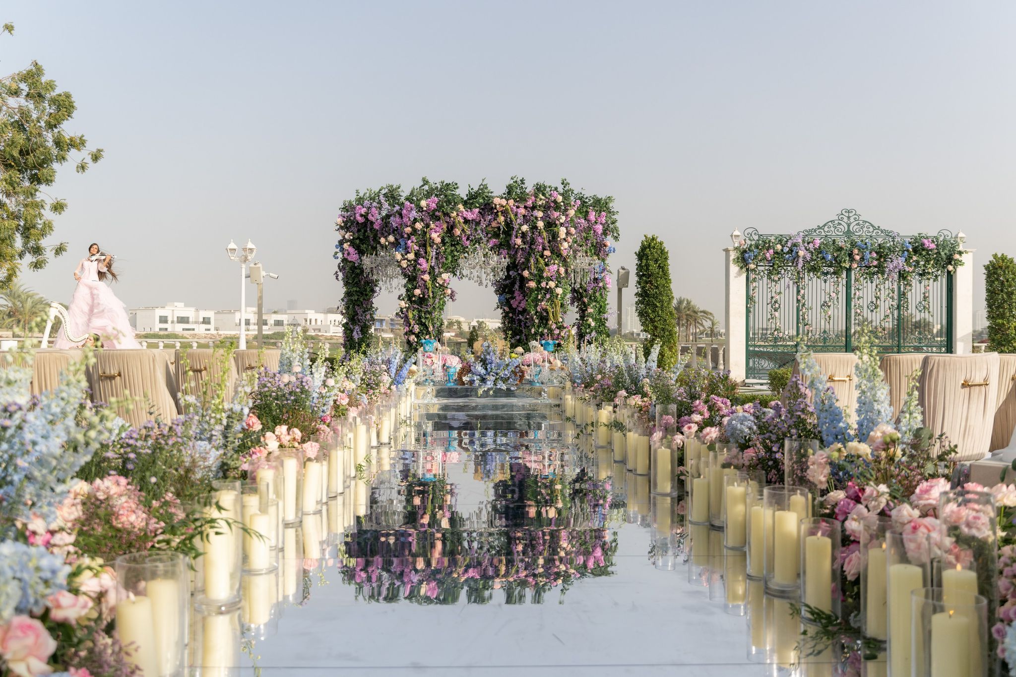 Candlelit mirrored aisle leading to a wisteria canopy at Four Seasons Resort Dubai at Jumeirah Beach