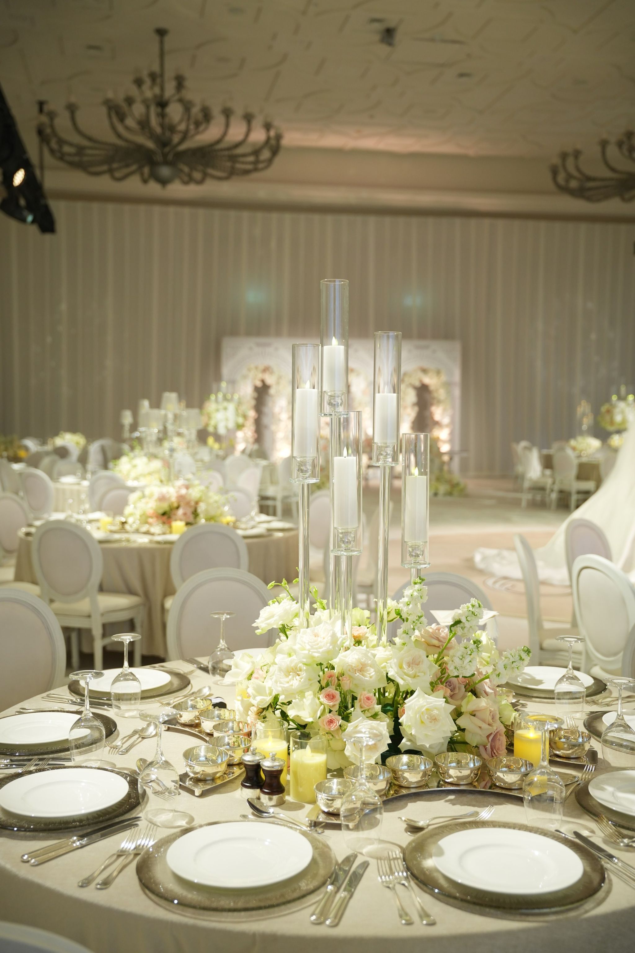Candelabra and white roses on a guest table in the ballroom at Four Seasons Resort Dubai at Jumeirah Beach