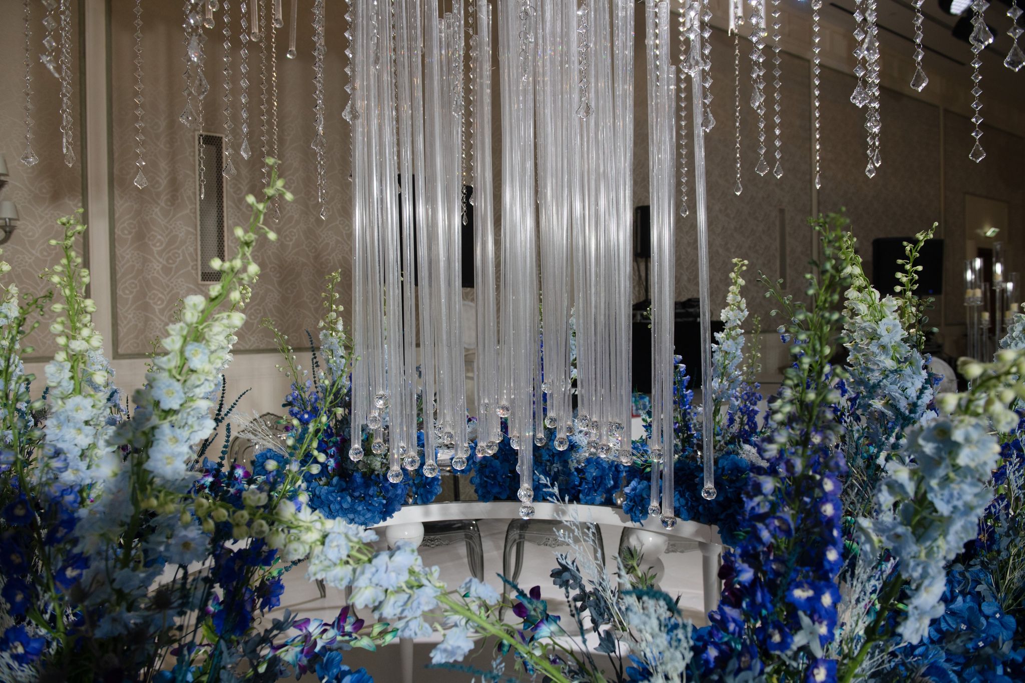 Strands of crystal falling into a bed of pale blue delphiniums and deep blue hydrangeas