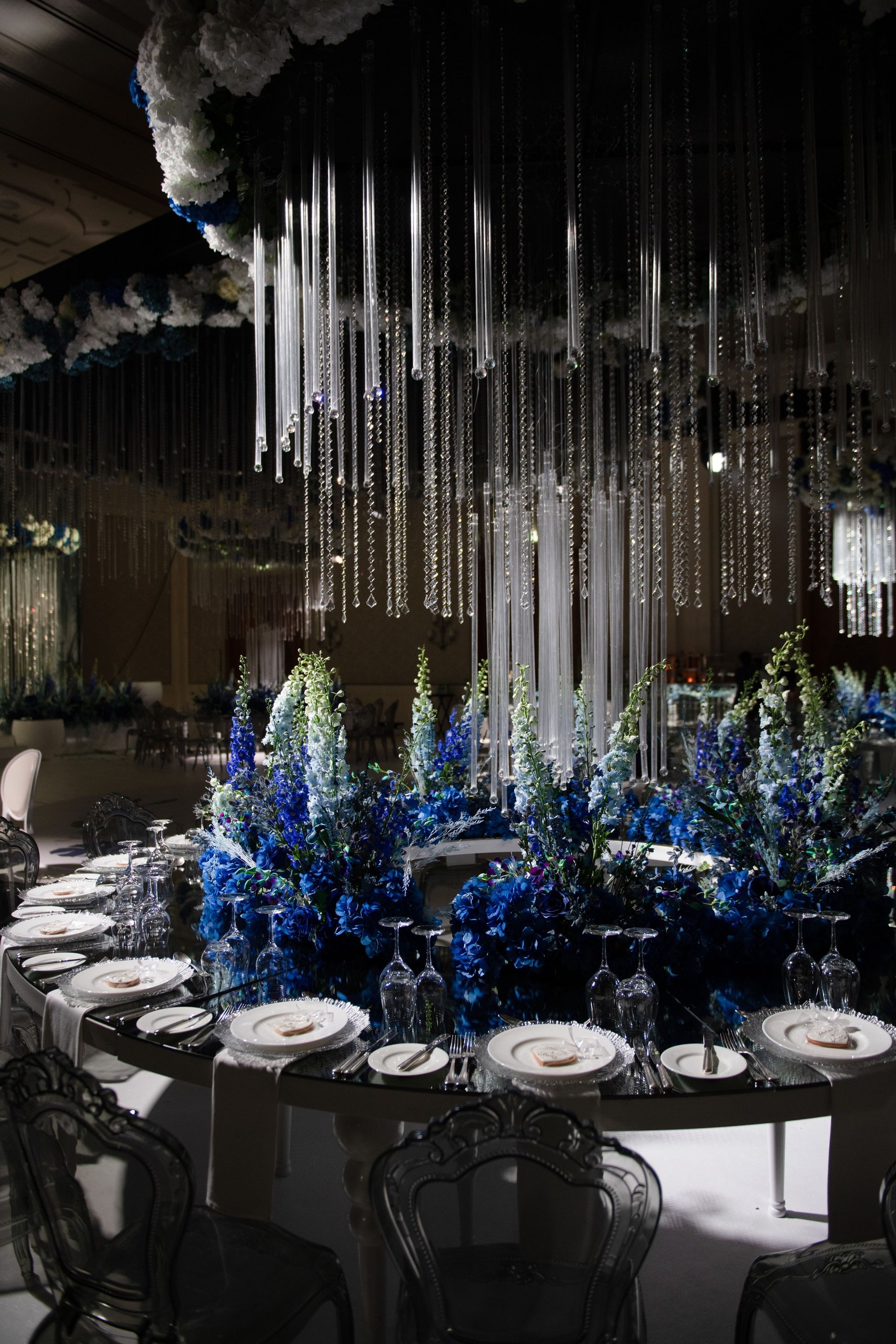 Mirrored table of cobalt hydrangeas and delphiniums beneath curtains of crystal at Four Seasons Resort Dubai at Jumeirah Beach