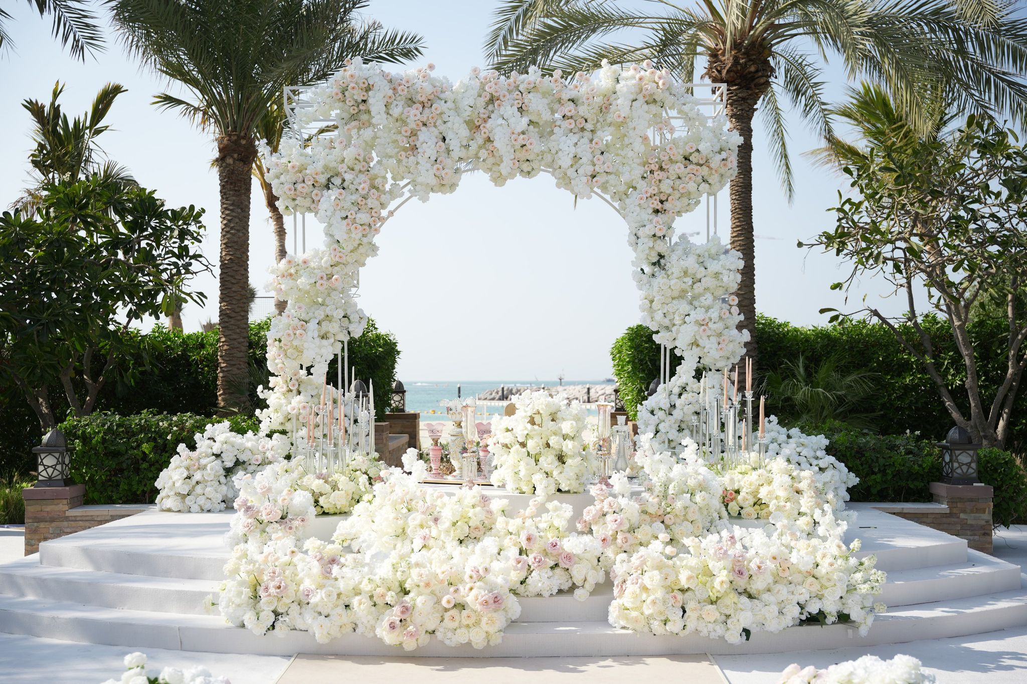 Rose arch framing the sea above a stepped stage at Four Seasons Resort Dubai at Jumeirah Beach