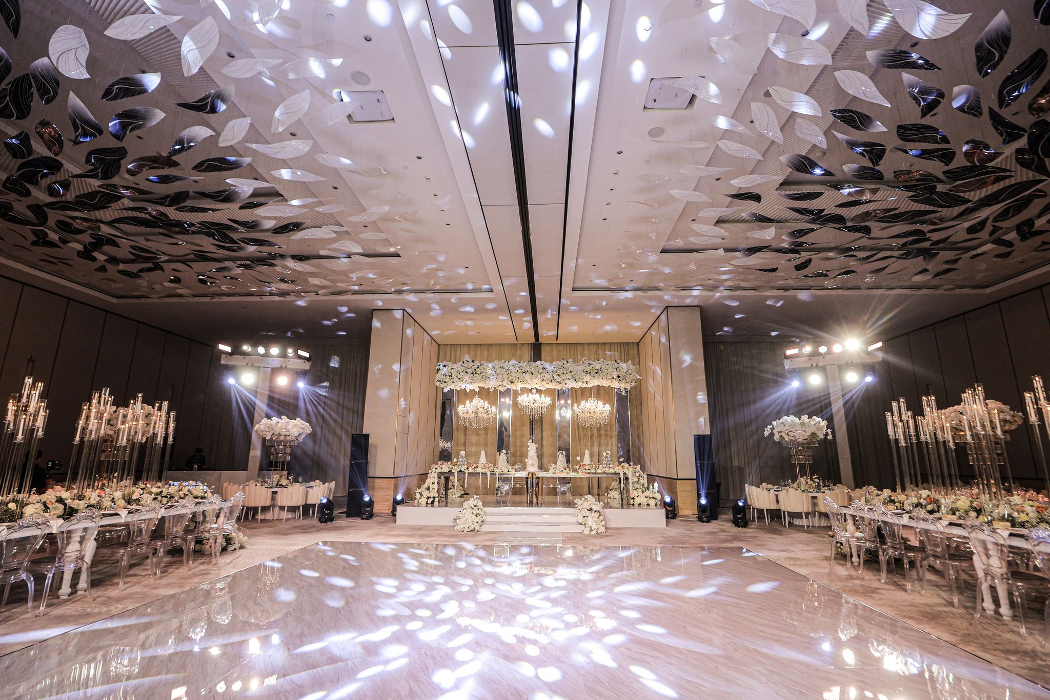 Ballroom at The St. Regis Dubai, The Palm with a mirrored dance floor, sculpted leaf ceiling and floral stage