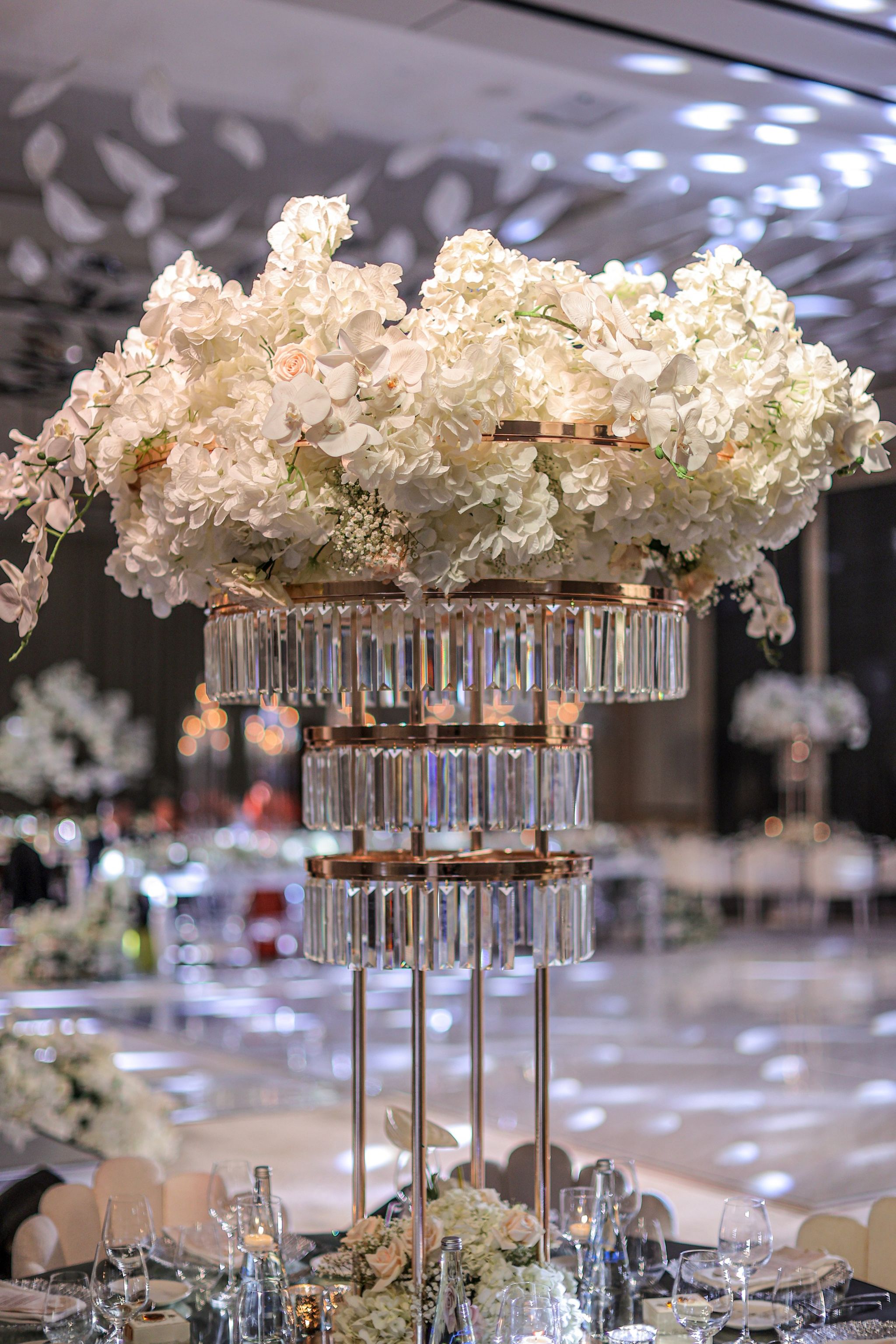 White orchid and hydrangea centrepiece on a three-tier crystal stand in the ballroom at The St. Regis Dubai, The Palm