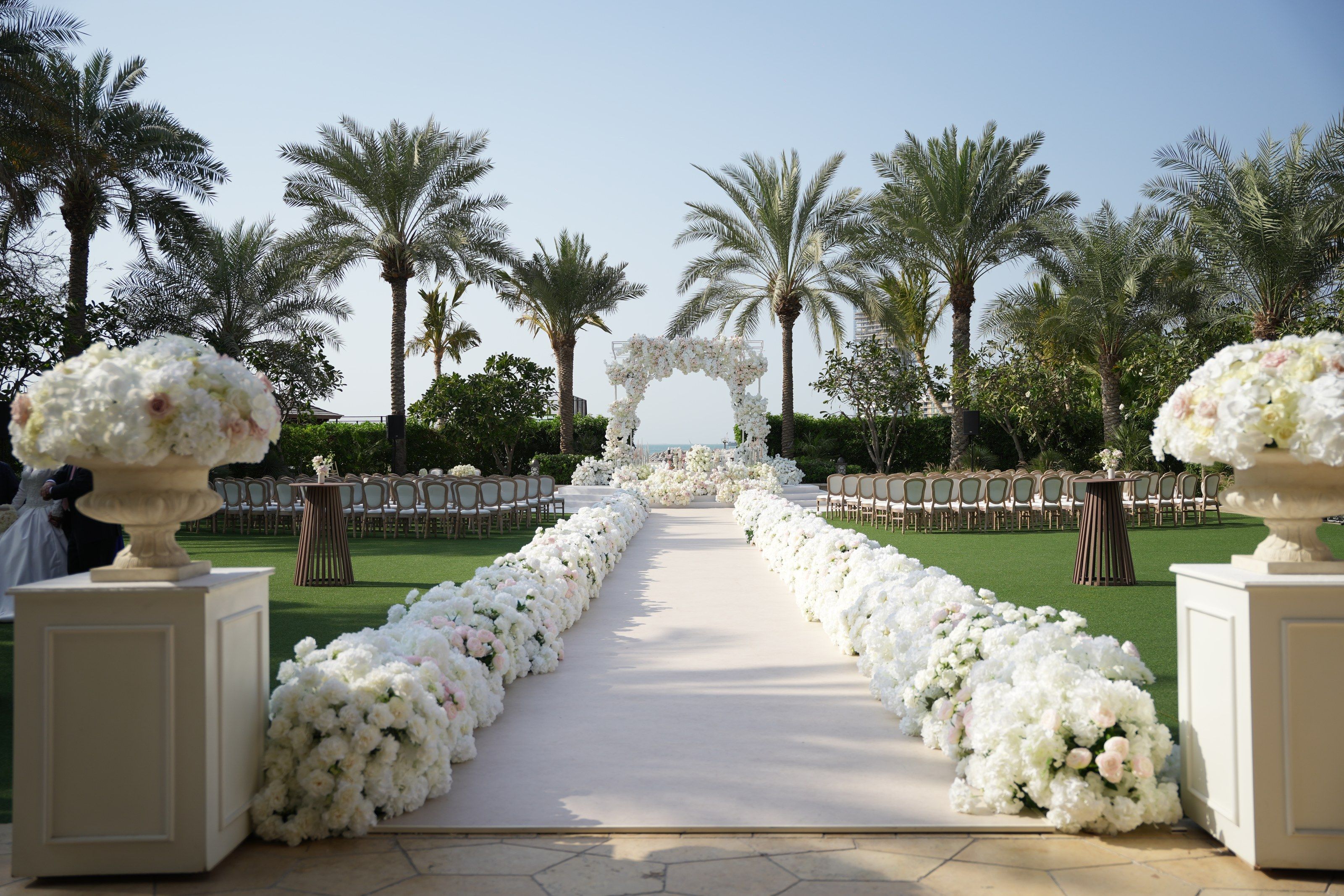Hydrangea-lined aisle leading to a floral arch at Four Seasons Resort Dubai at Jumeirah Beach