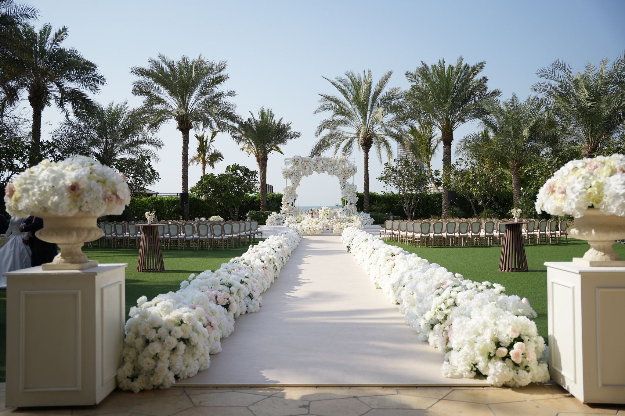Hydrangea-lined aisle leading to a floral arch at Four Seasons Resort Dubai at Jumeirah Beach