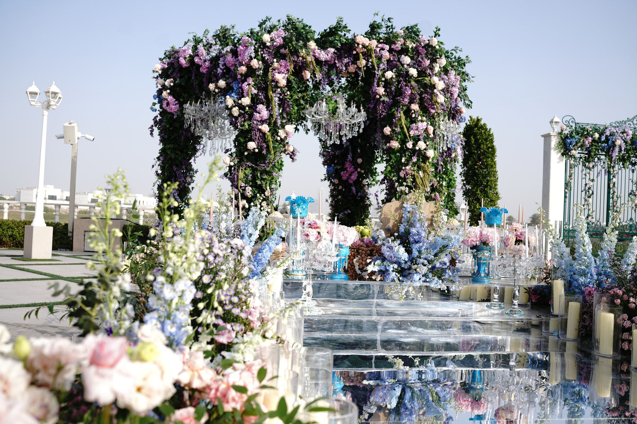 Chandelier-hung floral canopy above a mirrored ceremony stage at Four Seasons Resort Dubai at Jumeirah Beach
