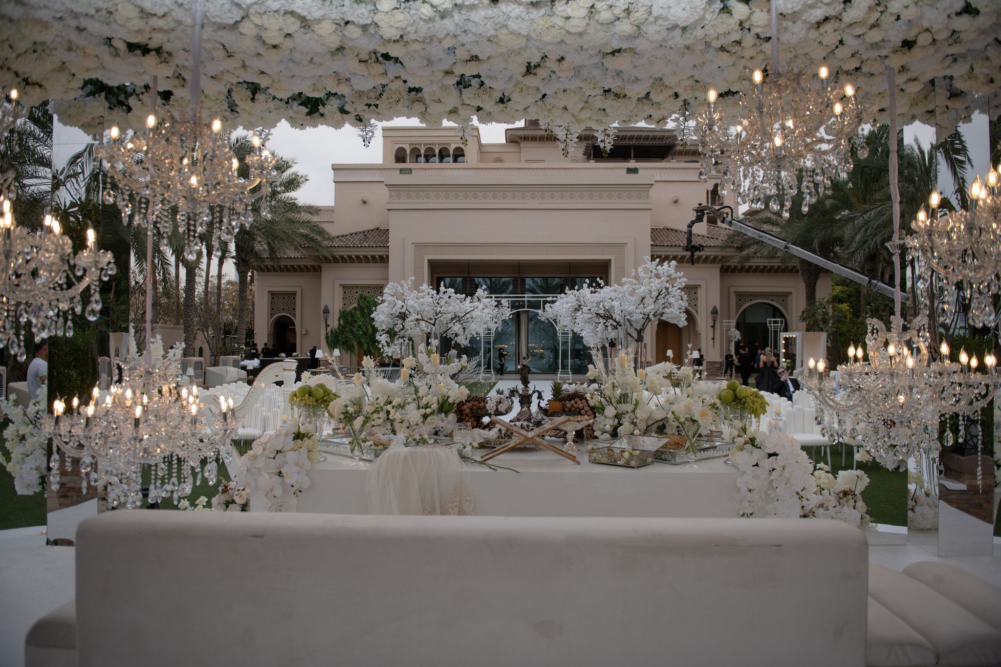 Chandeliers and a floral canopy framing the sofreh aghd at Four Seasons Resort Dubai at Jumeirah Beach