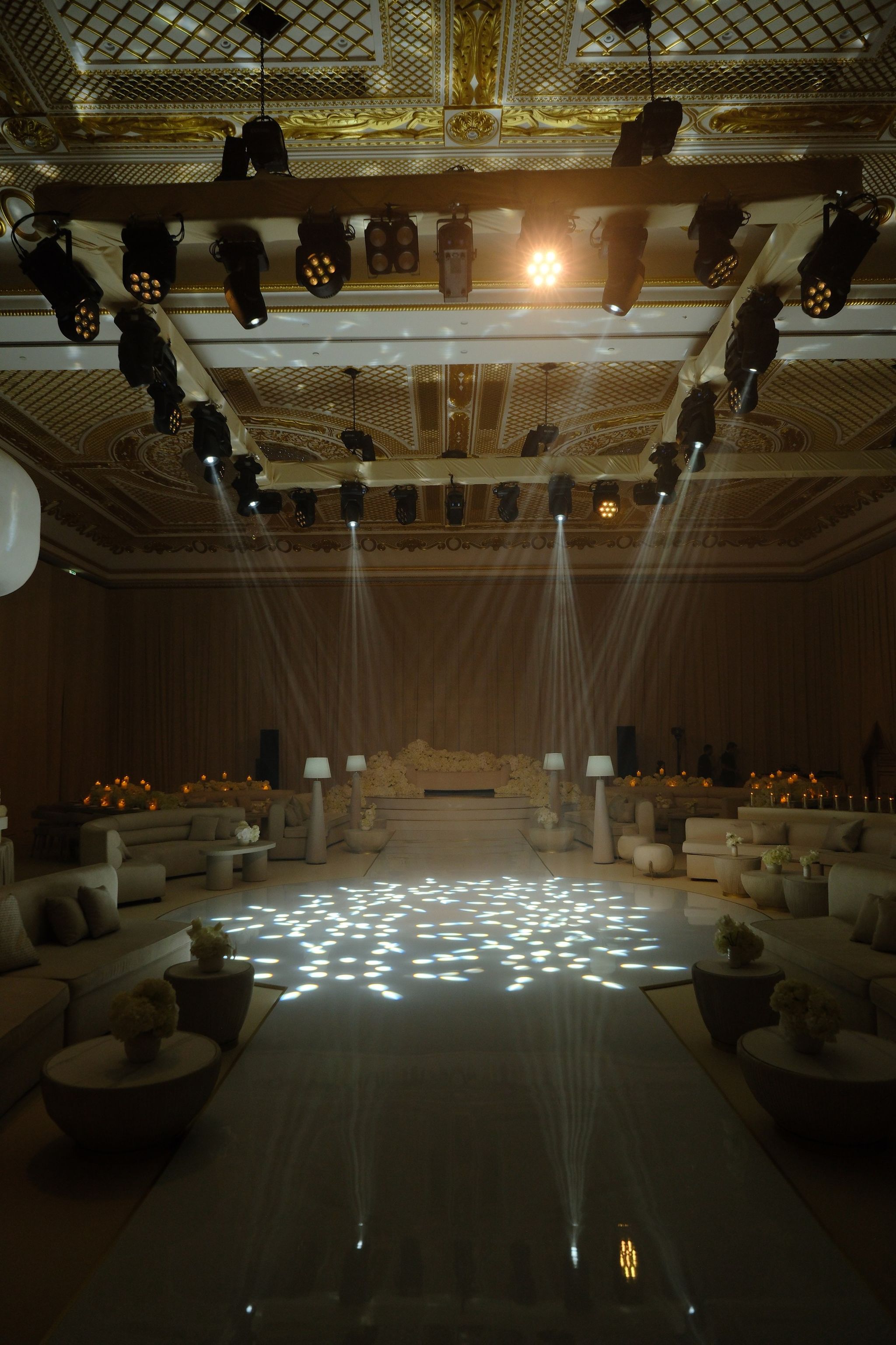 White grand piano framed by hydrangeas and pillar candles in the ballroom at Raffles The Palm Dubai