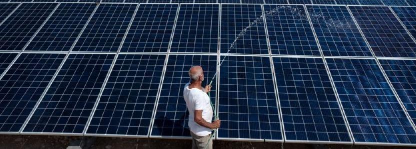 Date farmer Ahmad takes care of new solar panels installed by Oxfam in Jordan Valley, Palestine