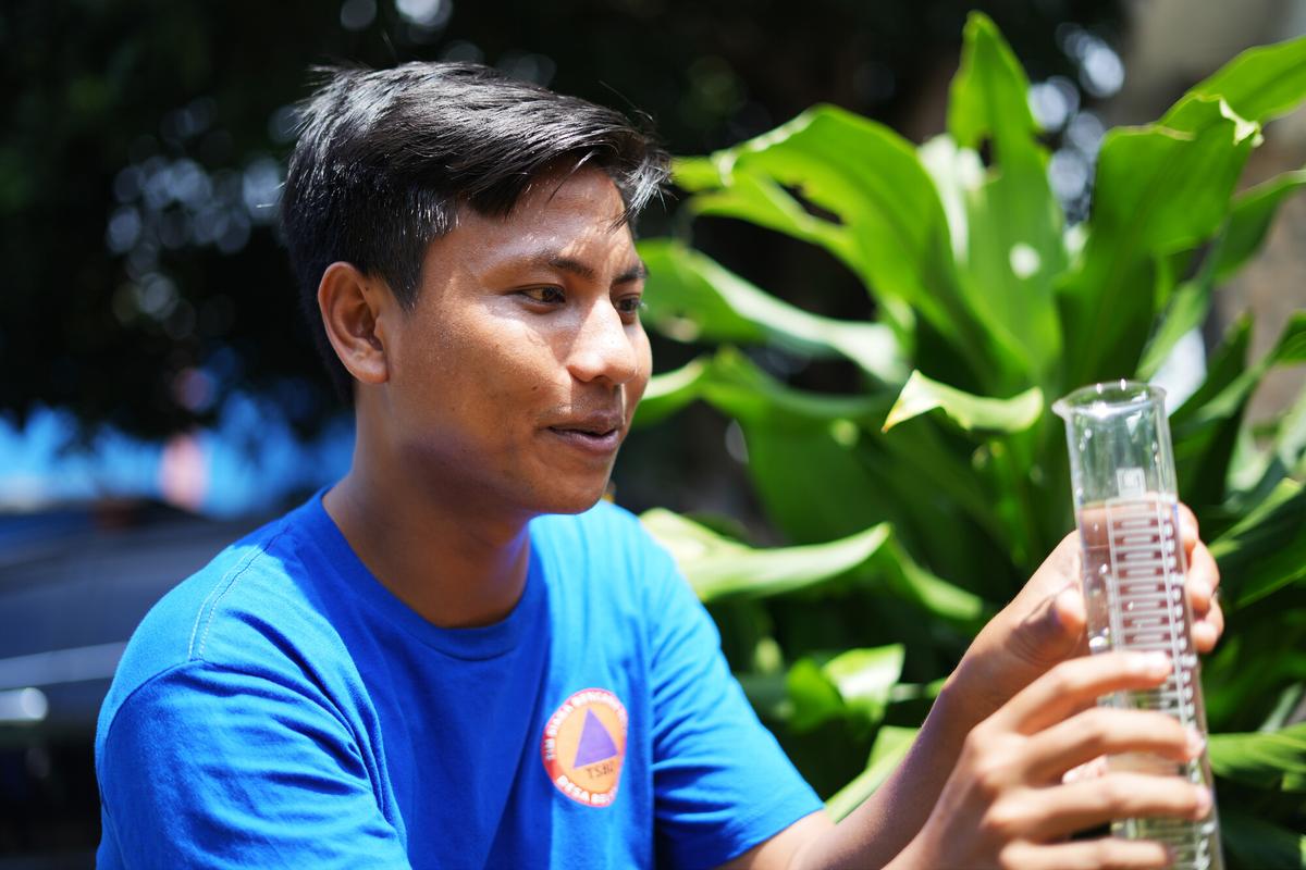 Indonesia: Wiranto is part of the community's Village Disaster Preparedness team (TSBD), and compiles data from the ombrometer to predict potential flash flooding. Photo: Aimee Han/Oxfam