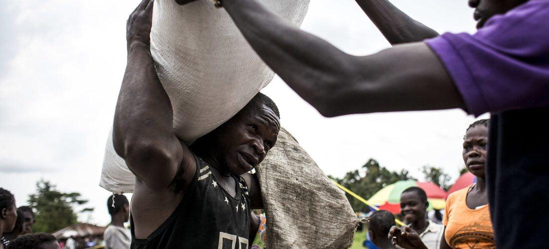 Man carries sack food in Kasai province of DR Congo