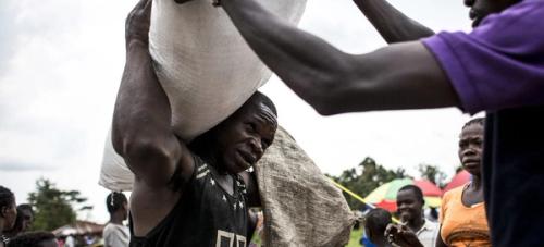 Man carries sack food in Kasai province of DR Congo