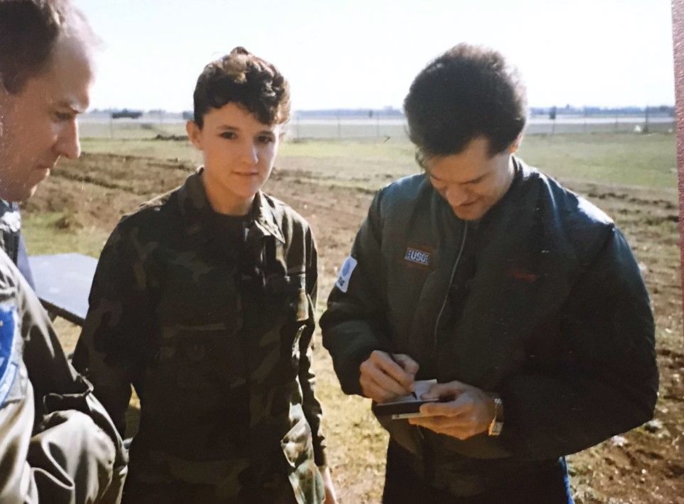 Cat and Dewey getting a Randy Travis autograph on the flightline during a USO tour