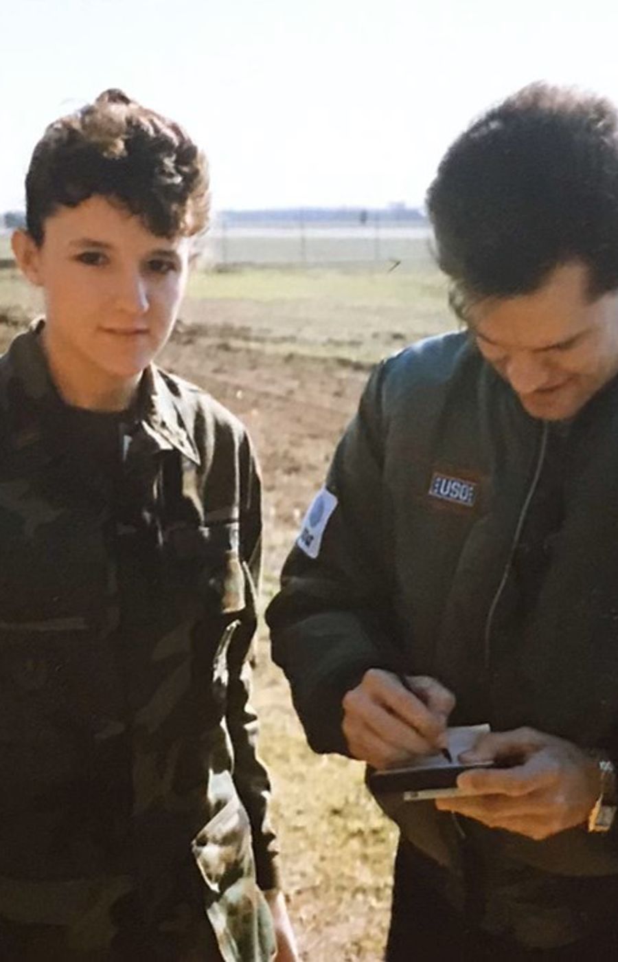 Cat and Dewey getting a Randy Travis autograph on the flightline during a USO tour