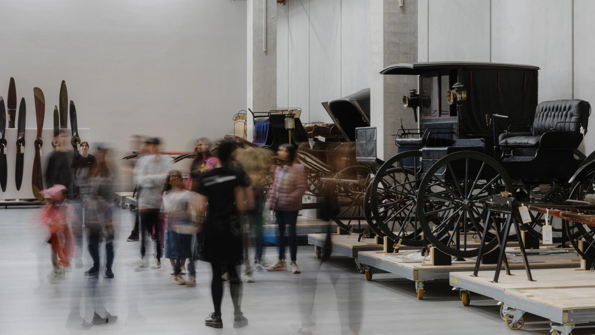 Photo of a group of people viewing collection objects at Powerhouse Castle Hill.