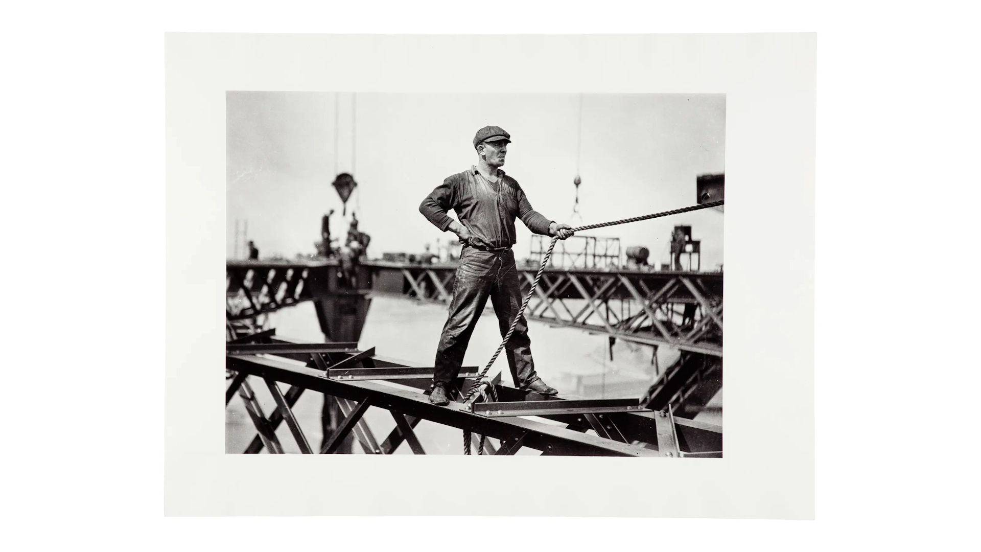 The images document the construction of the Sydney Harbour Bridge. Each print has a white border. Sign from exhibition and copy negative of sign.