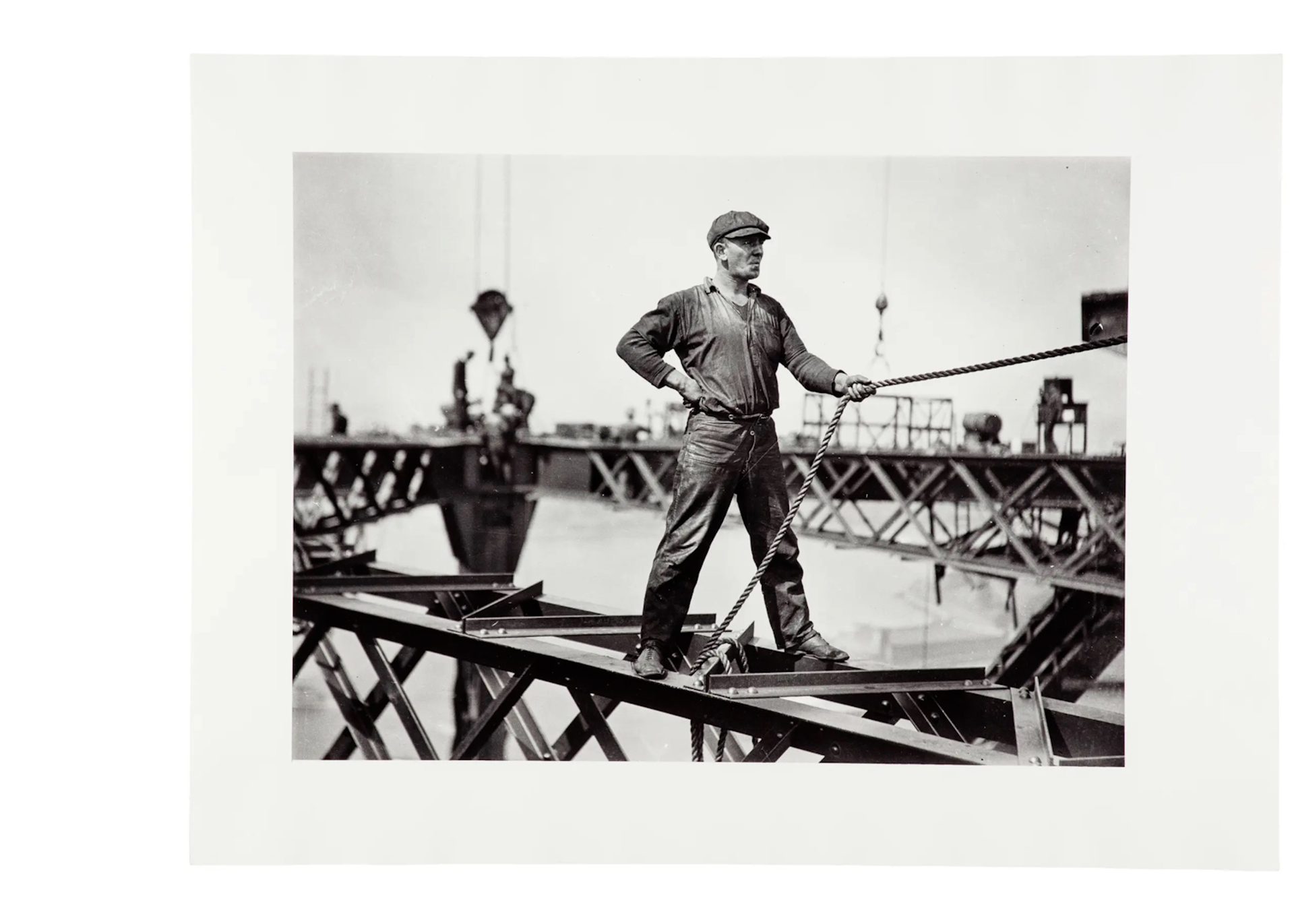 The images document the construction of the Sydney Harbour Bridge. Each print has a white border. Sign from exhibition and copy negative of sign.