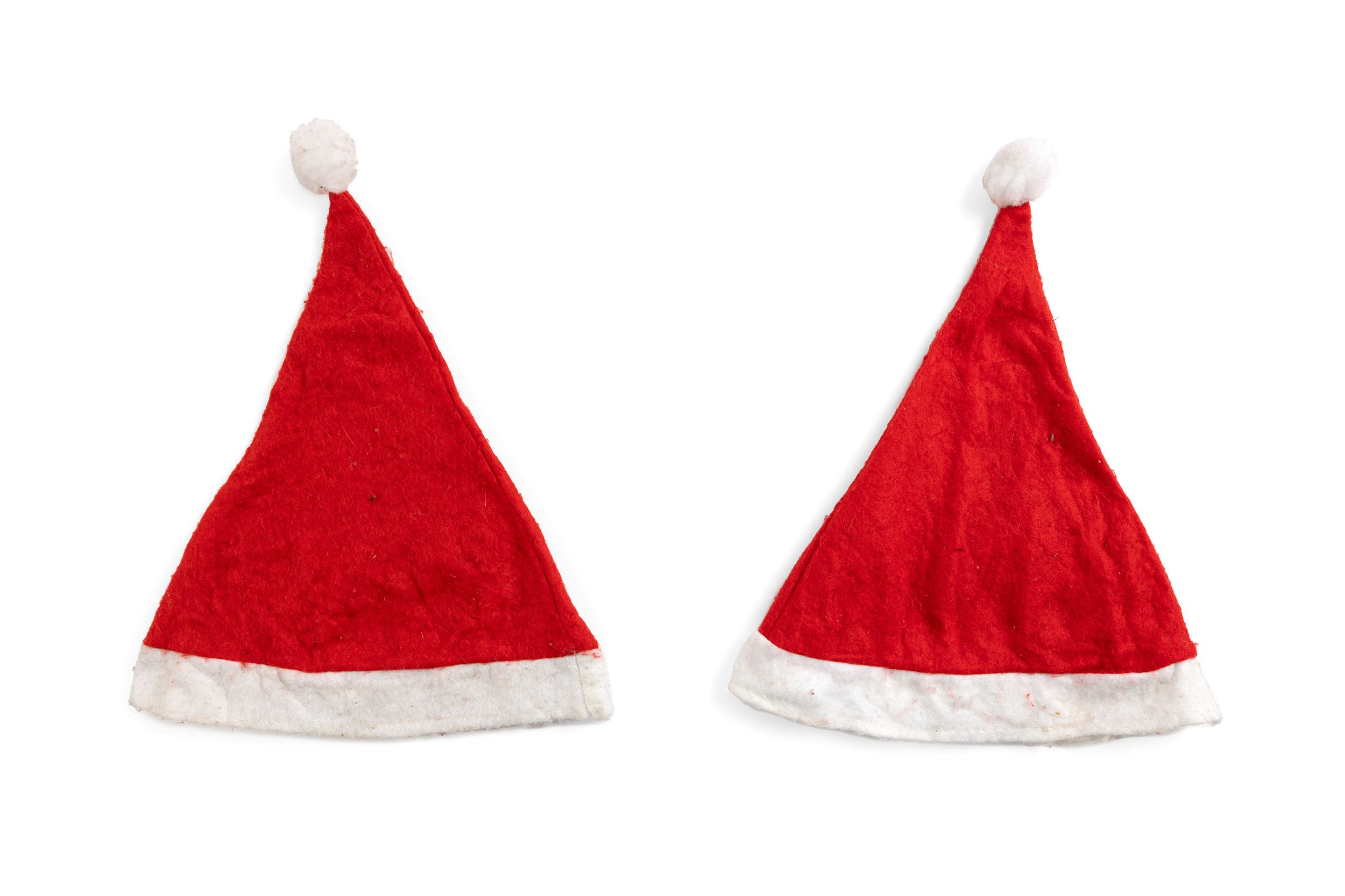 Two conical red felt Santa hats with white pompoms.