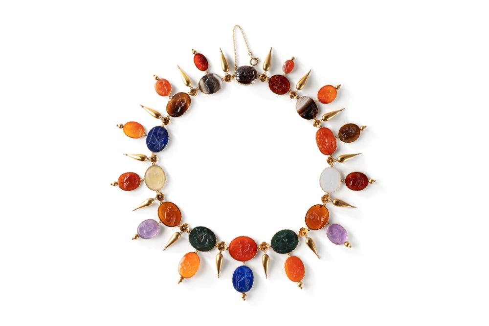 A necklace made out of gold, agate, amethyst, bloodstone, carnelian, garnet, lapis lazuli, onyx, and intaglios.