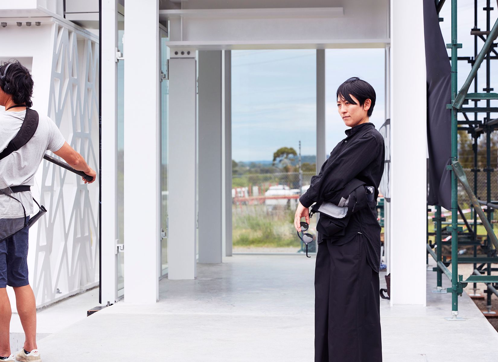 person standing by themselves next to exoskeleton