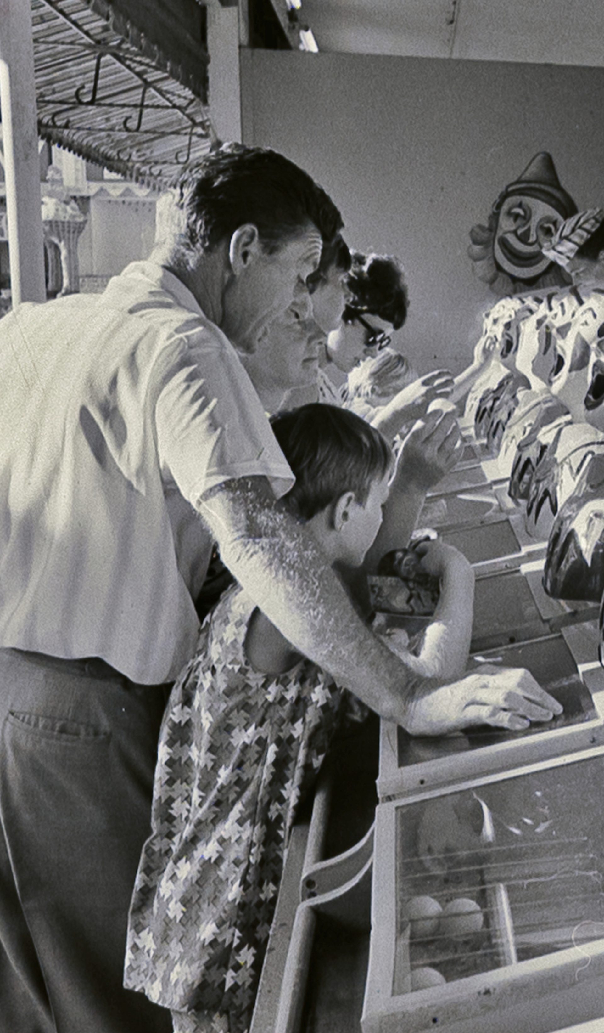 Photograph from negative with the caption "Coney Island spells fun to the child in any grown-up. Beneath the Harbour Bridge Sydney has its own version of Coney Island inside the bizarre mouth of Luna Park right on the waterfront."