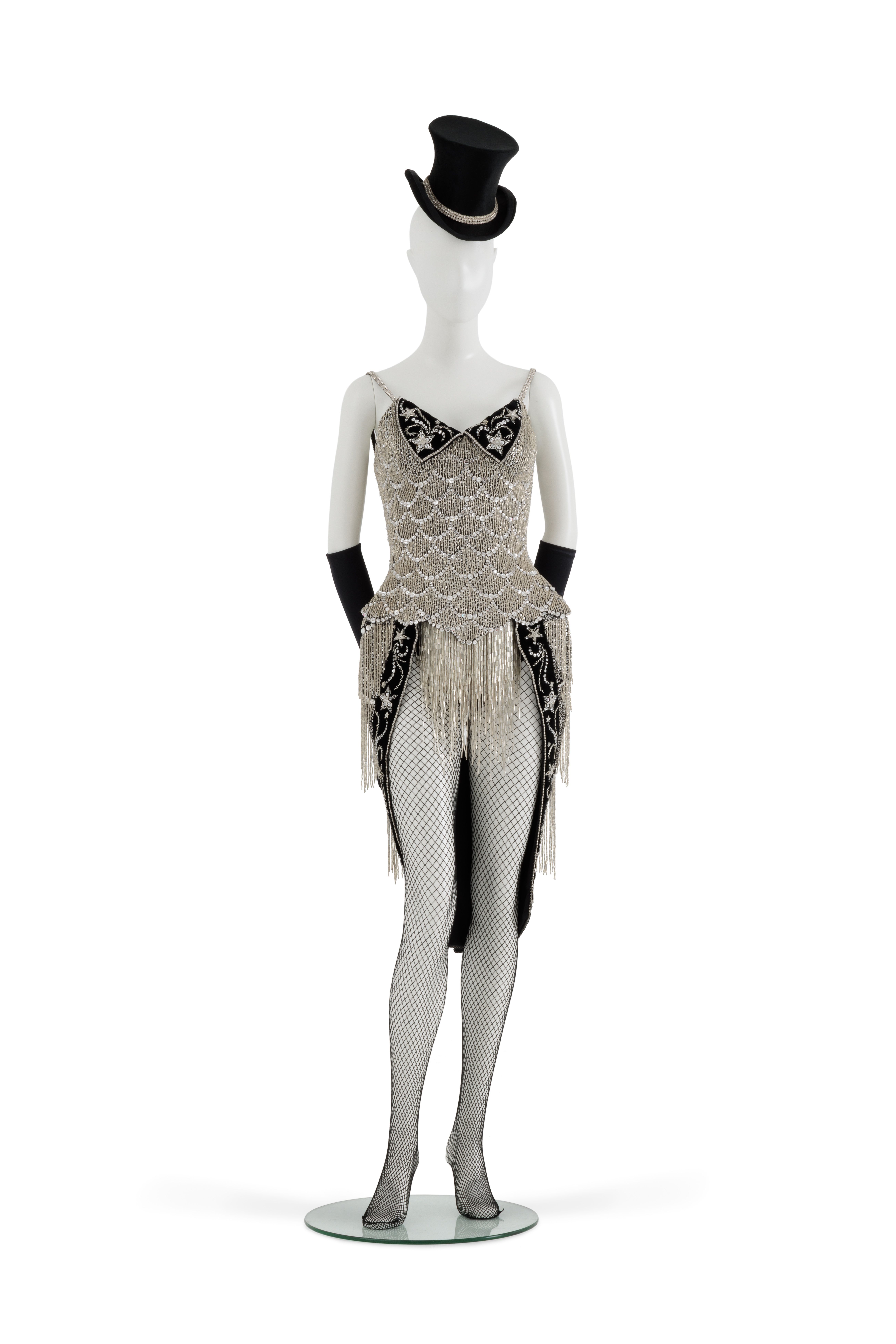'Black Diamonds' costume worn by Nicole Kidman, consisting of beaded and sequined corselet, top hat, gloves, panties, shoes and trapeze. Tailed corselet of black cotton, covered with heavily jewelled net. The corset has 24 bones, fastening with 14 metal eyelets, with 2 black cotton laces, one above and one below the waist. Insert at hips of quilted black satin. There are 2 padded inserts at each breast. There is a wide black satin panel tacked behind the lacing. The neckline at the front and under the arms is edged with black velvet to protect the wearer from the beads.