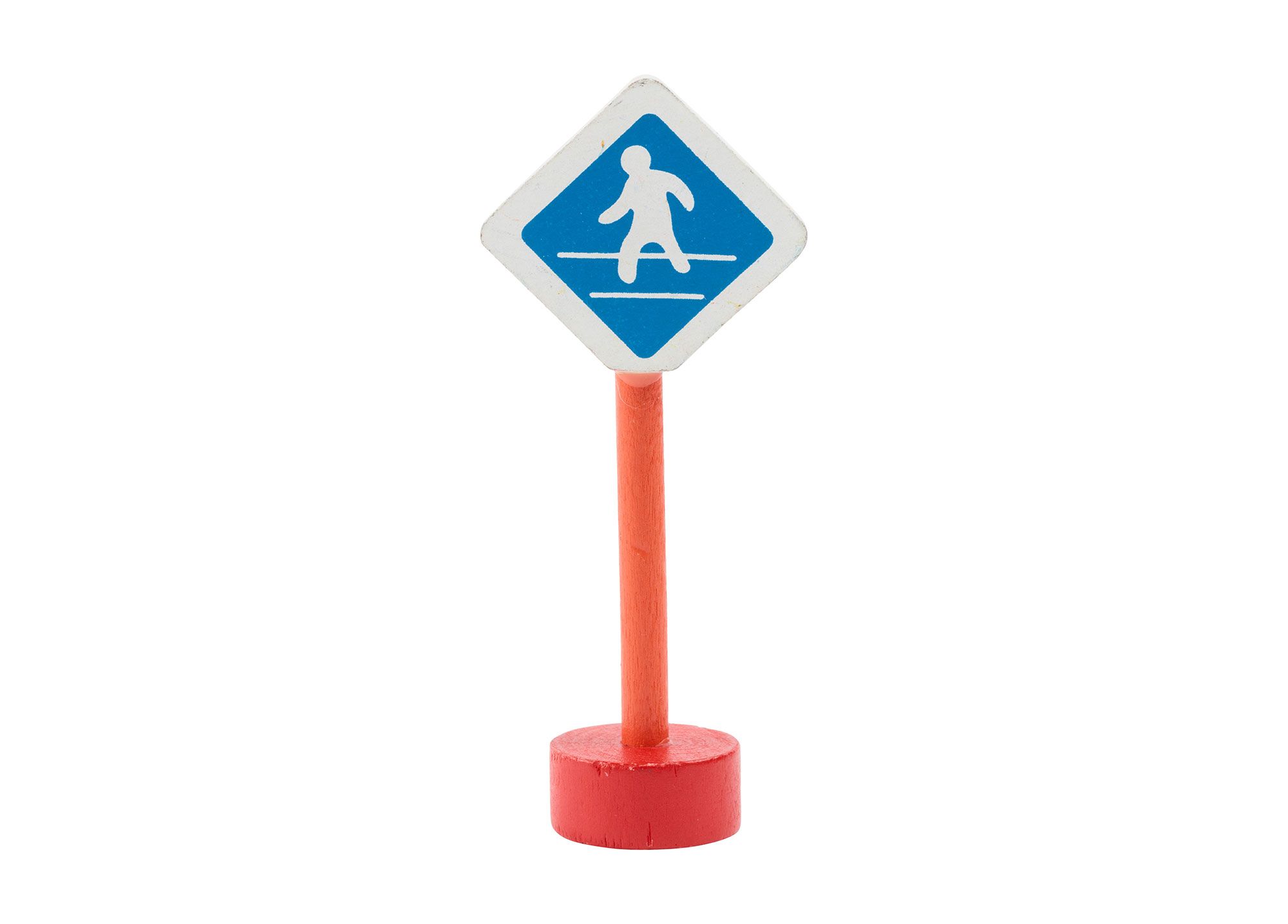Wooden toy pedestrian sign with a red base and pole and a diamond white and blue sign depicting a figure on a path.