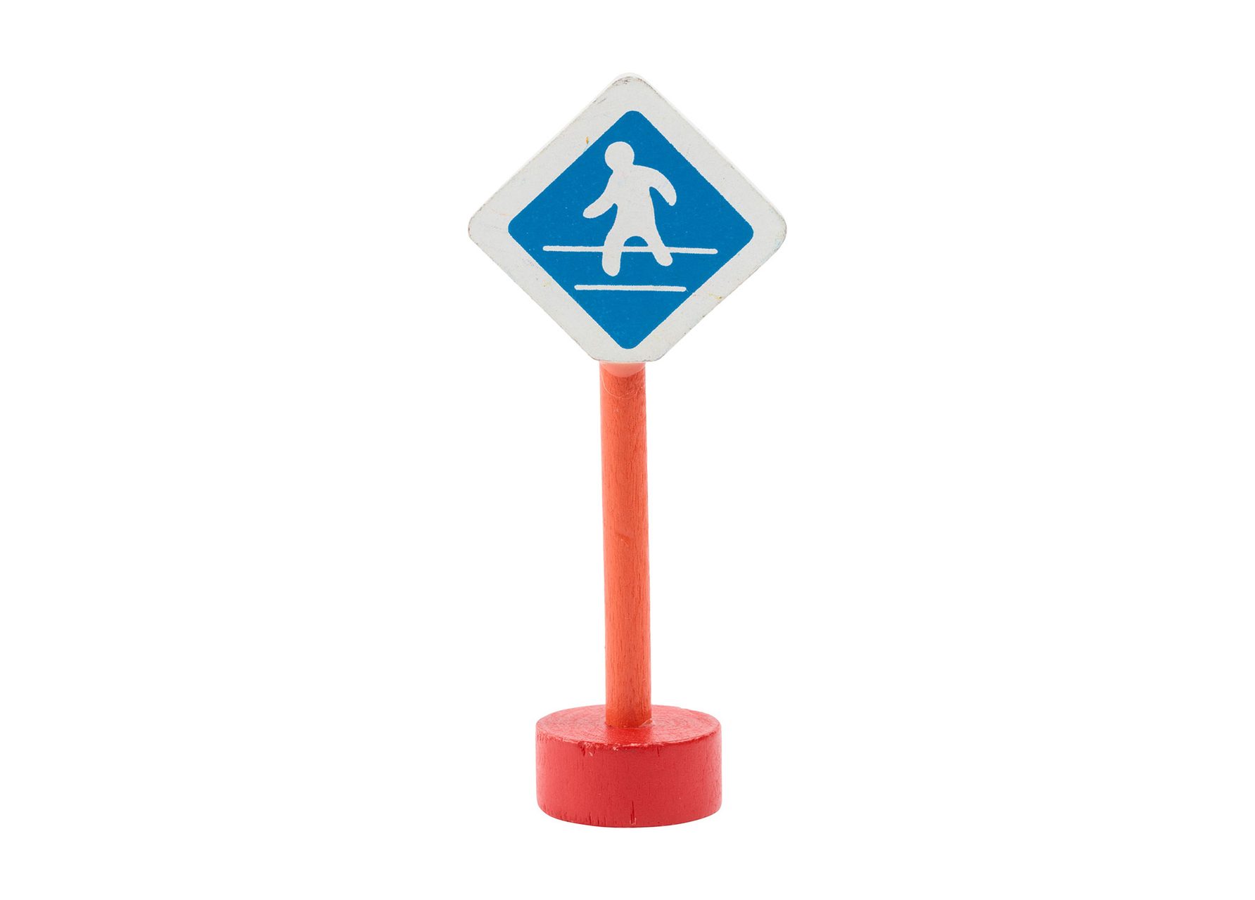 Wooden toy pedestrian sign with a red base and pole and a diamond white and blue sign depicting a figure on a path.
