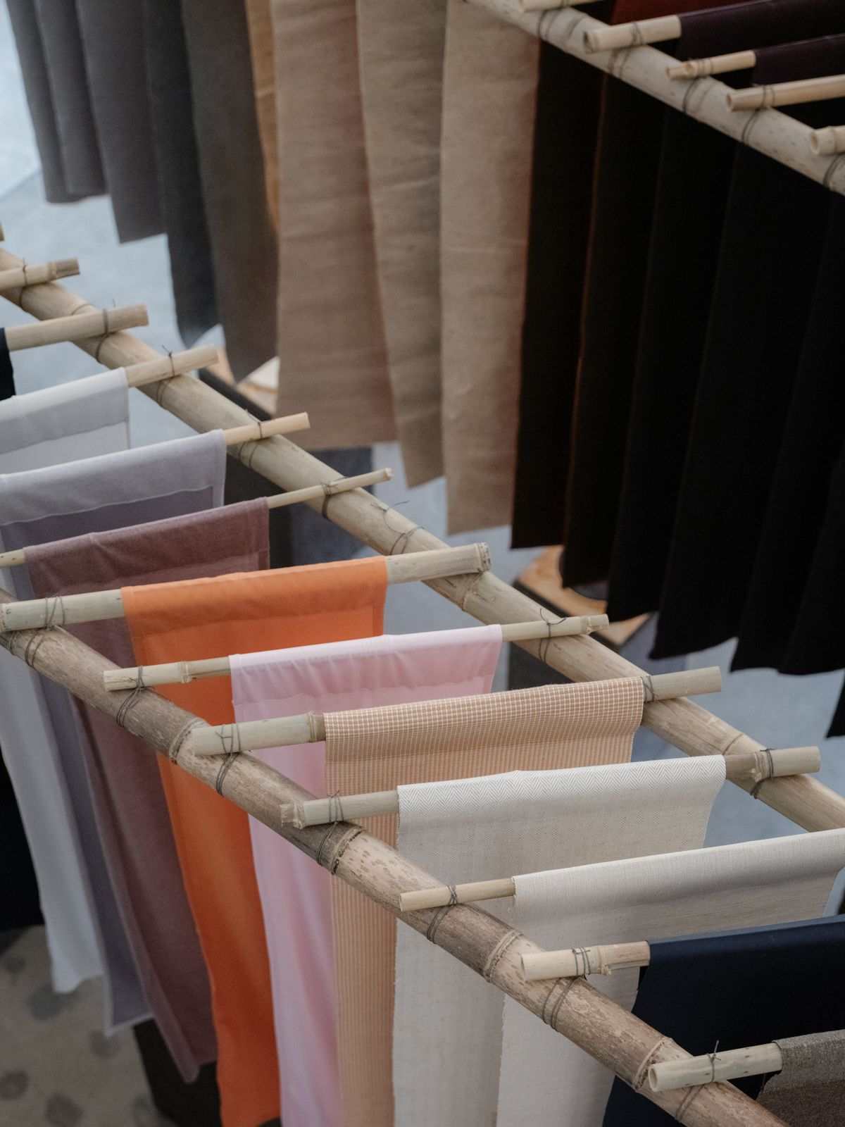 Colourful pieces of fabric hanging from babmboo