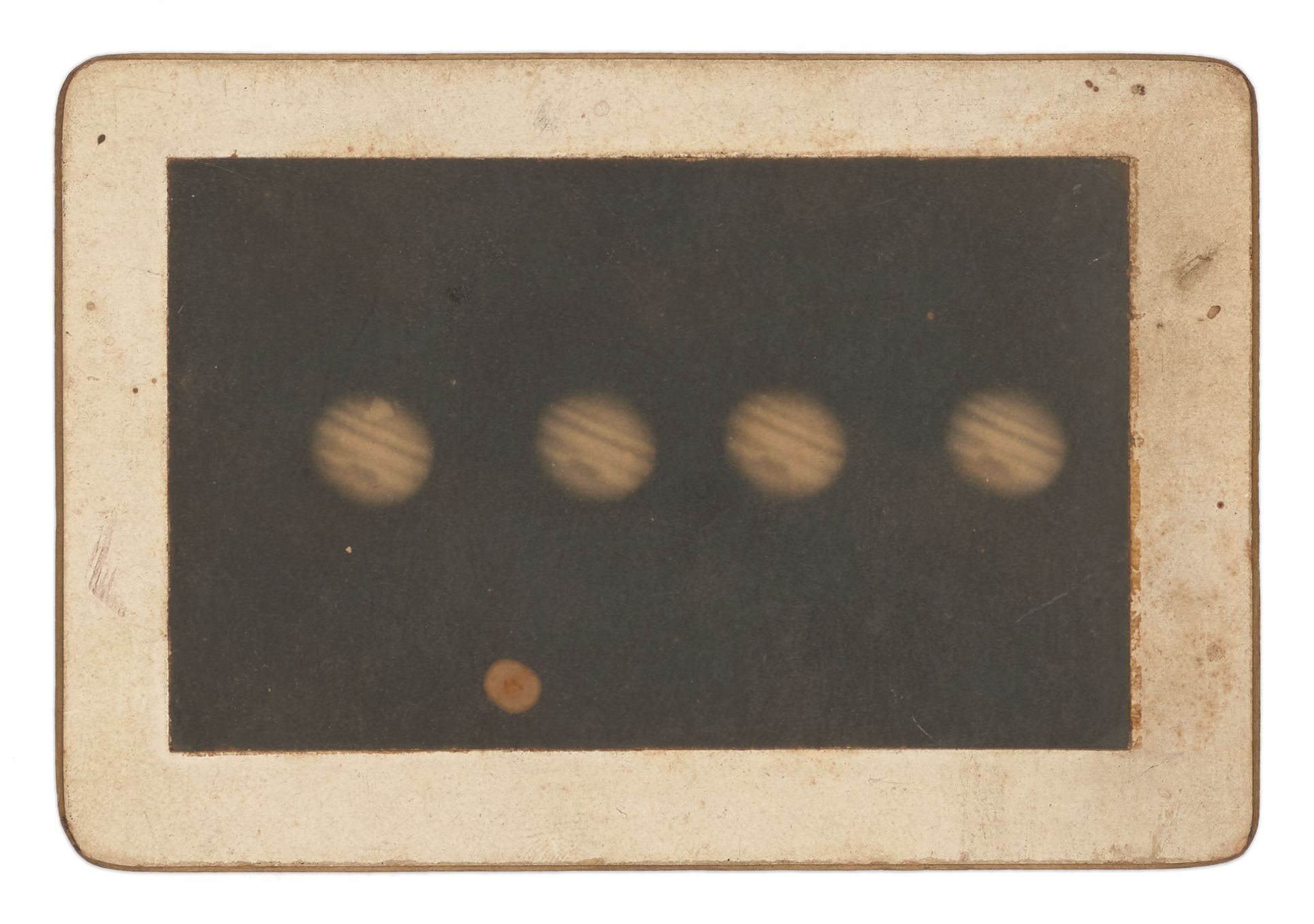 Black and white photograph of four images of Jupiter exposed in a single frame, mounted on stiff cardboard with gold painted edges. Caption on verso reads 'Jupiter'.
