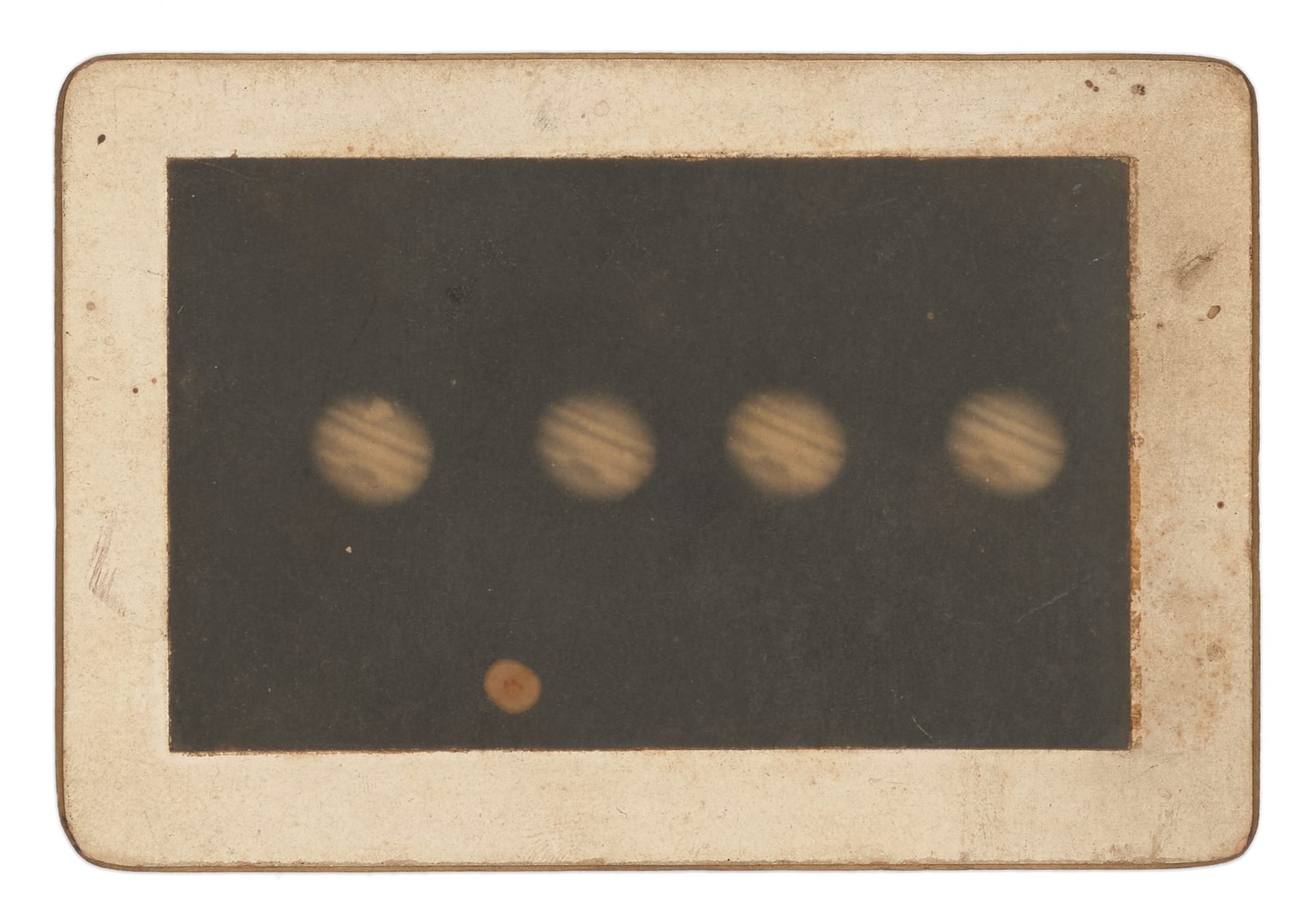 Black and white photograph of four images of Jupiter exposed in a single frame, mounted on stiff cardboard with gold painted edges. Caption on verso reads 'Jupiter'.