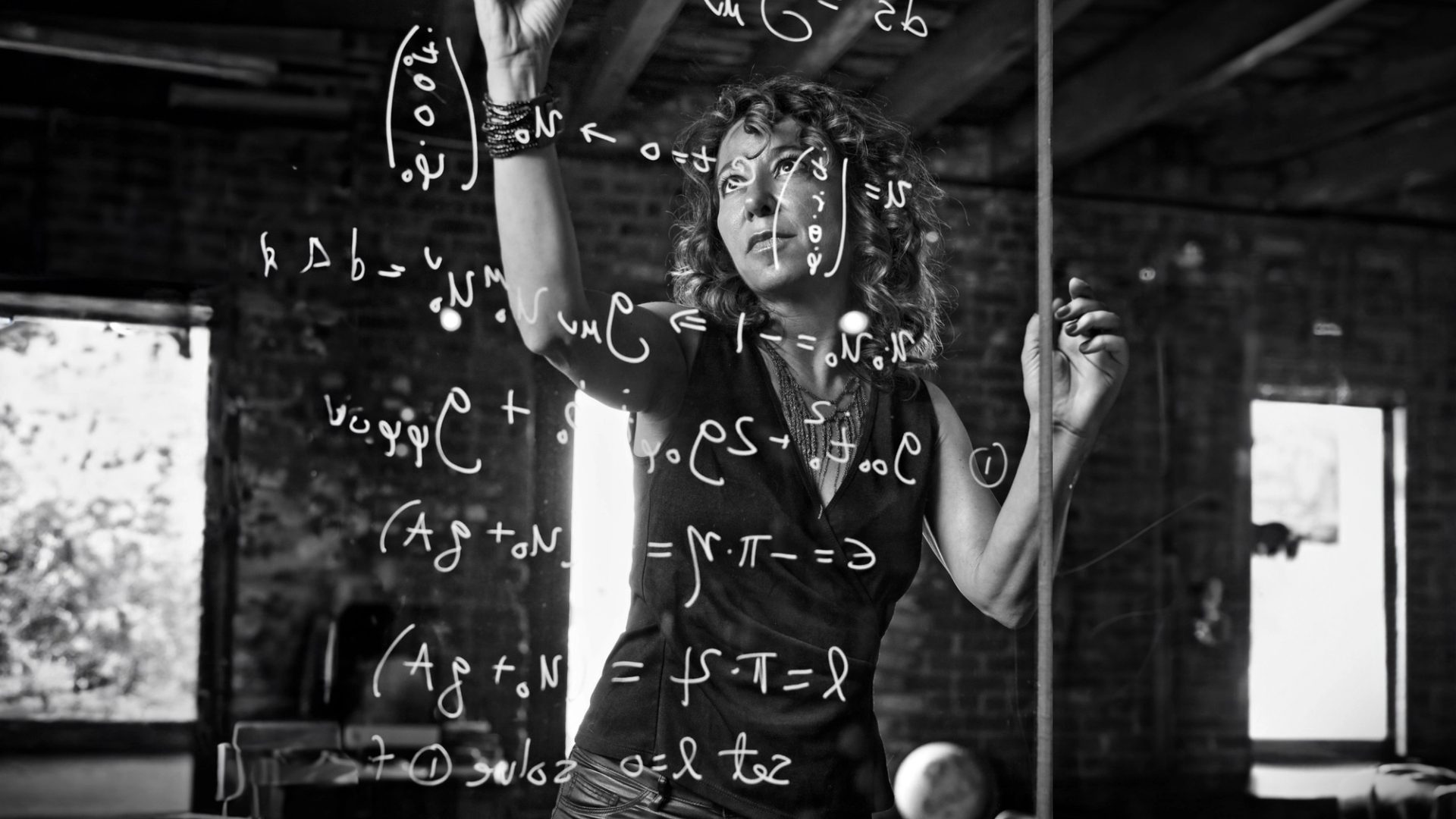 Woman writing on glass.