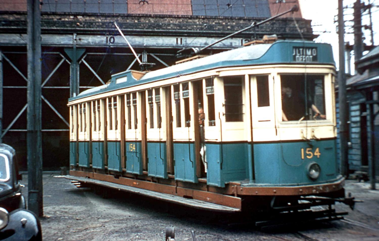 Vintage colour photograph of tram car outside yard