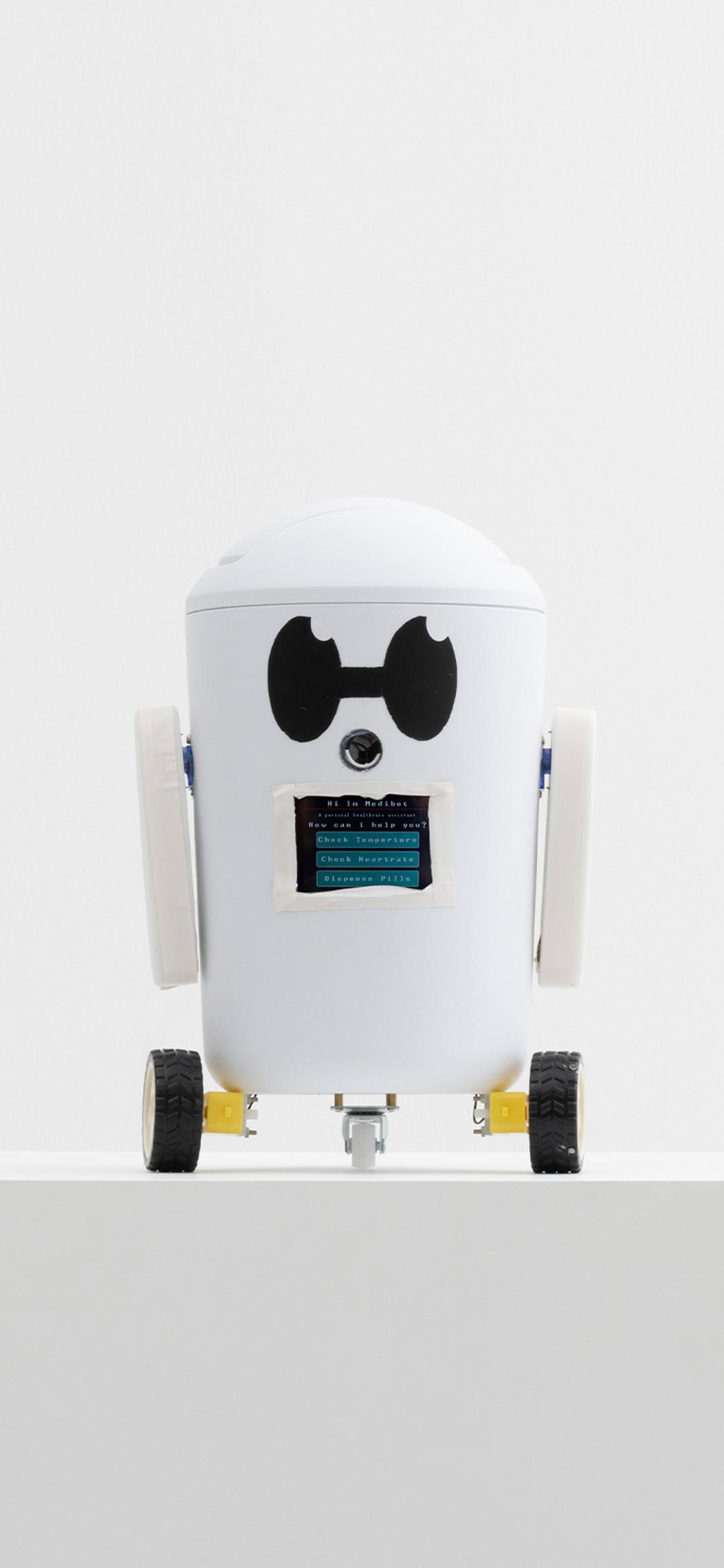 little white robot on wheels sitting on a plinth