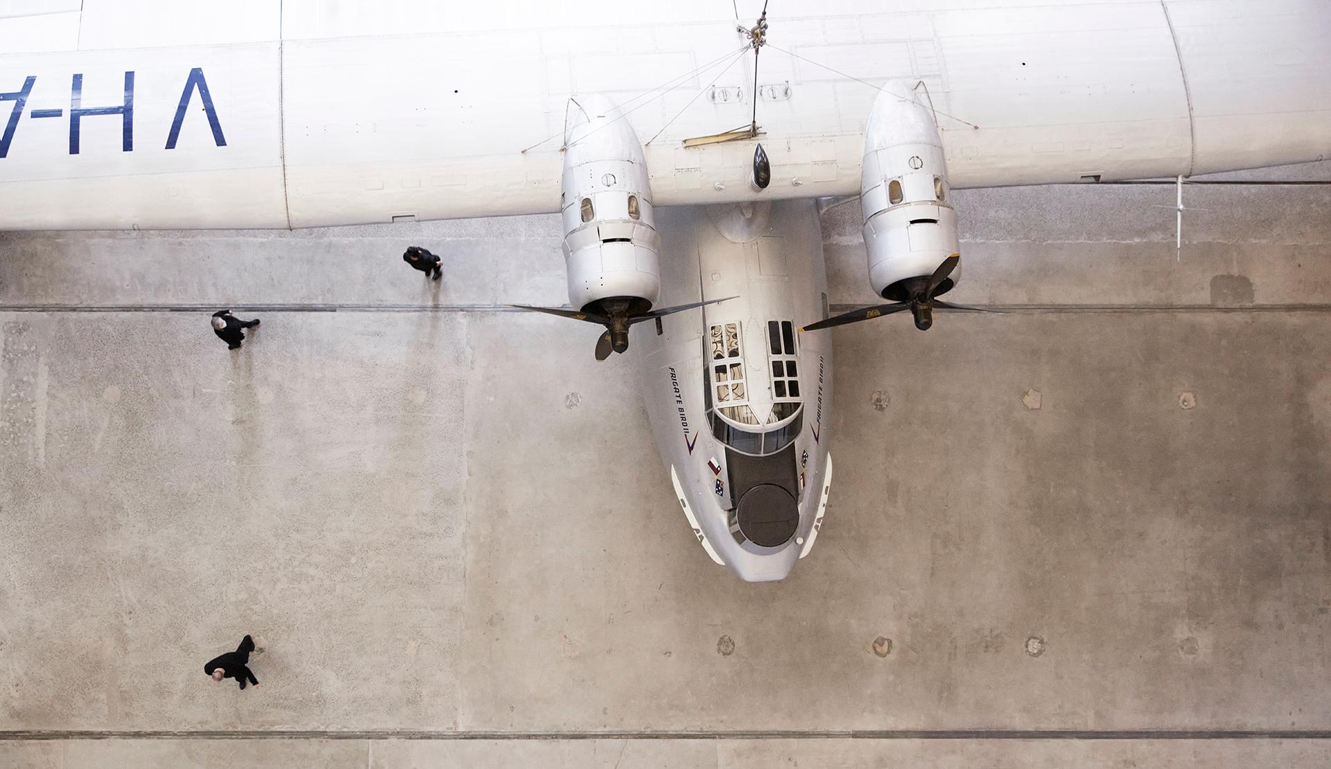 Aerial view of nose and wingspan of silver plane, Catalina Frigate Bird II
