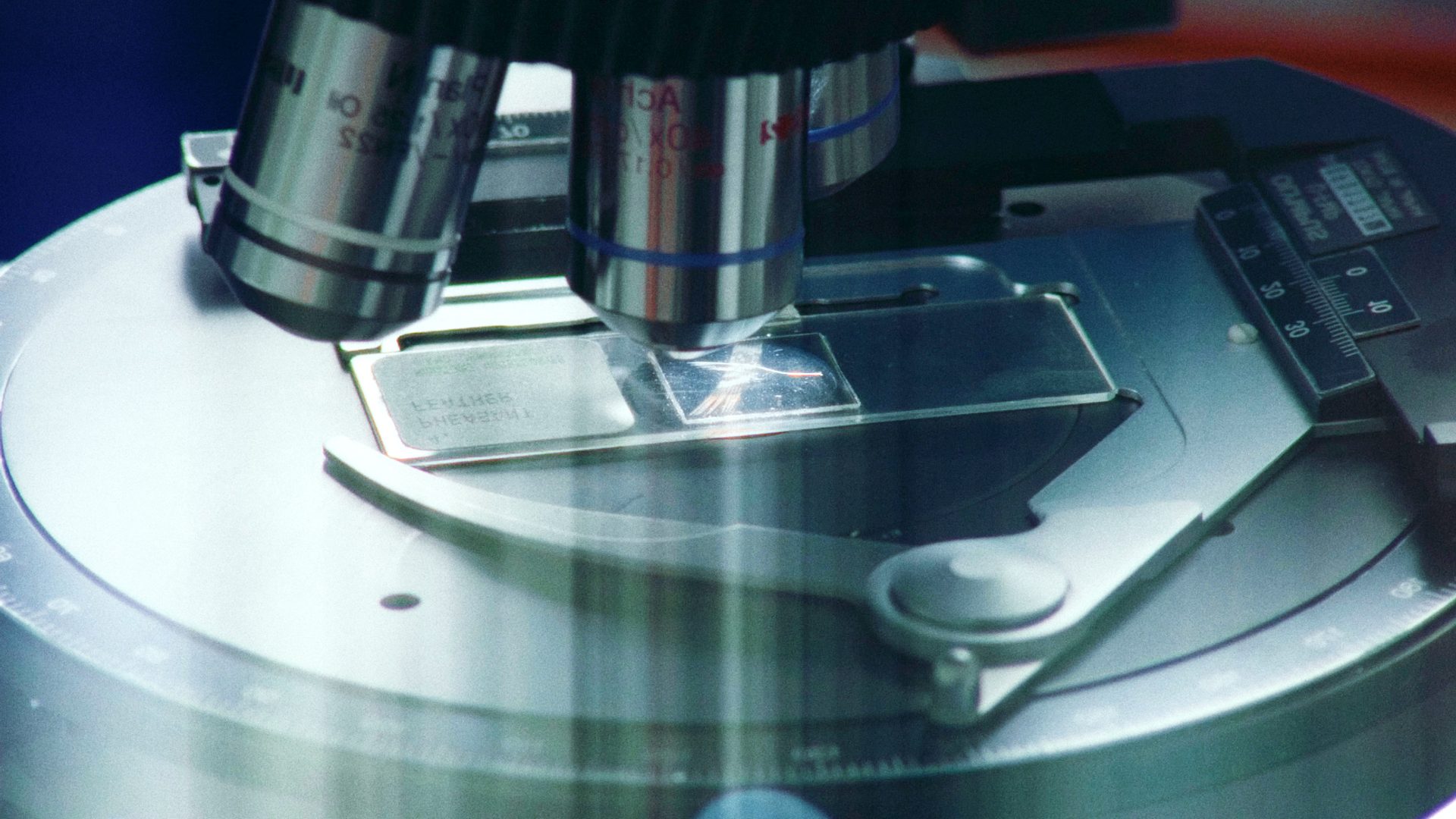 Microscope looking at glass slide.