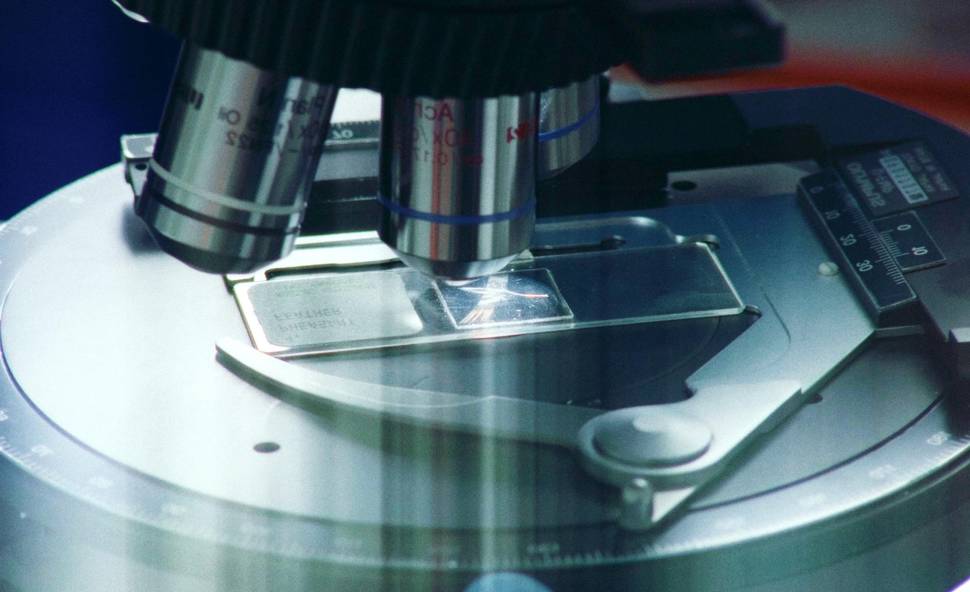 Microscope looking at glass slide.