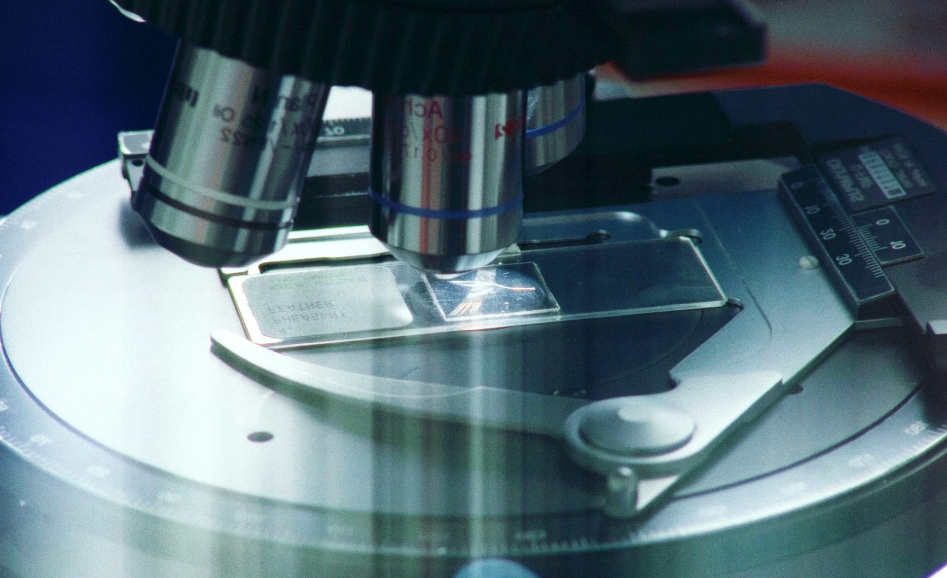 Microscope looking at glass slide.
