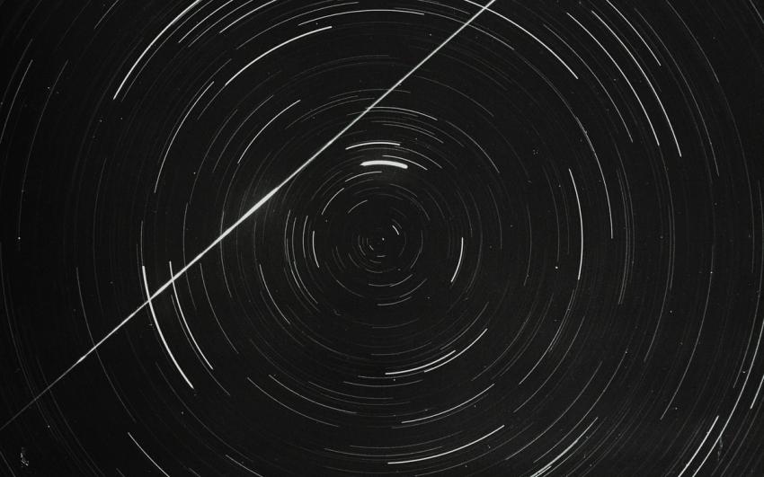 Lantern slide of meteor and star trails.