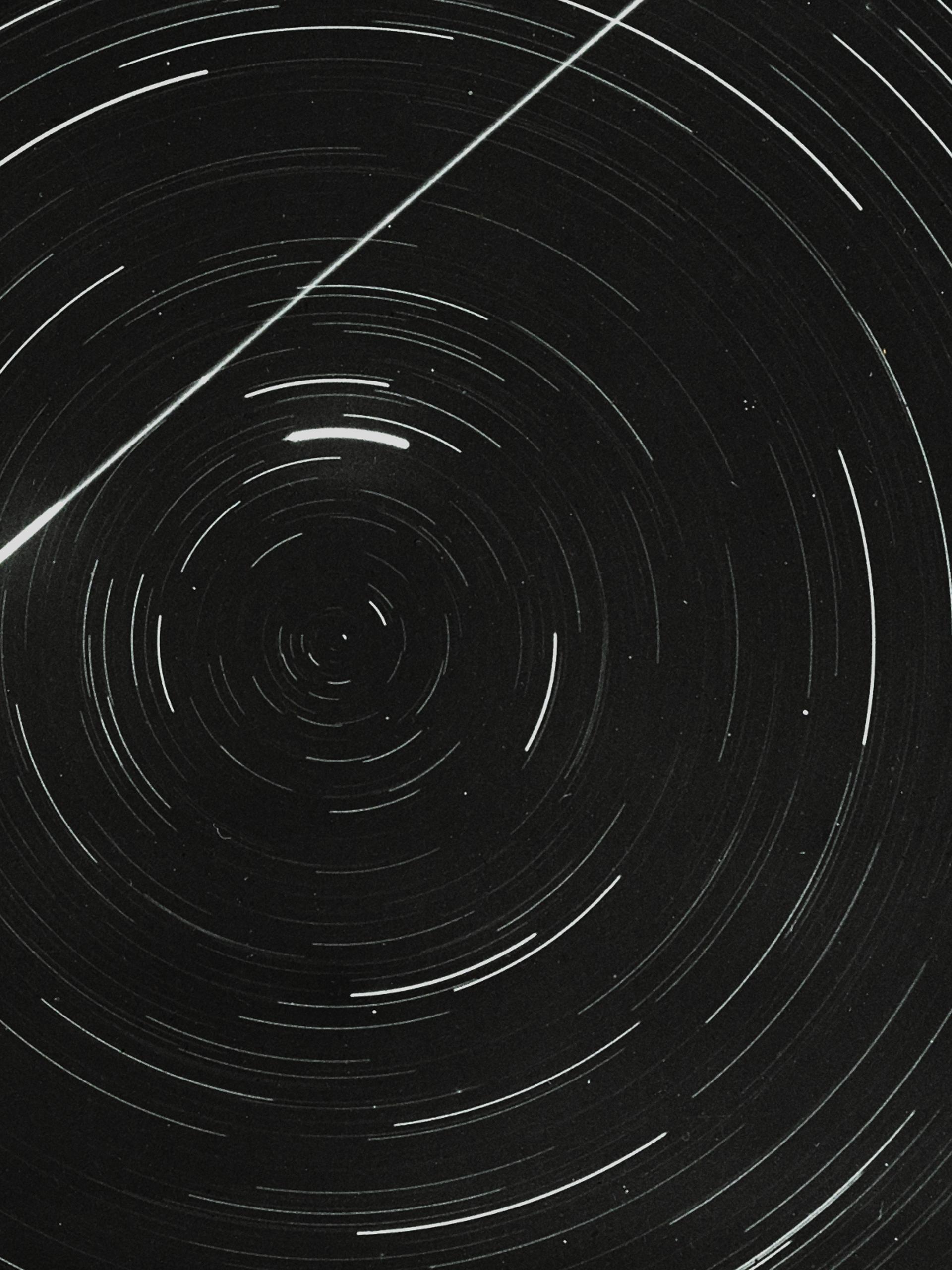 Lantern slide of meteor and star trails.