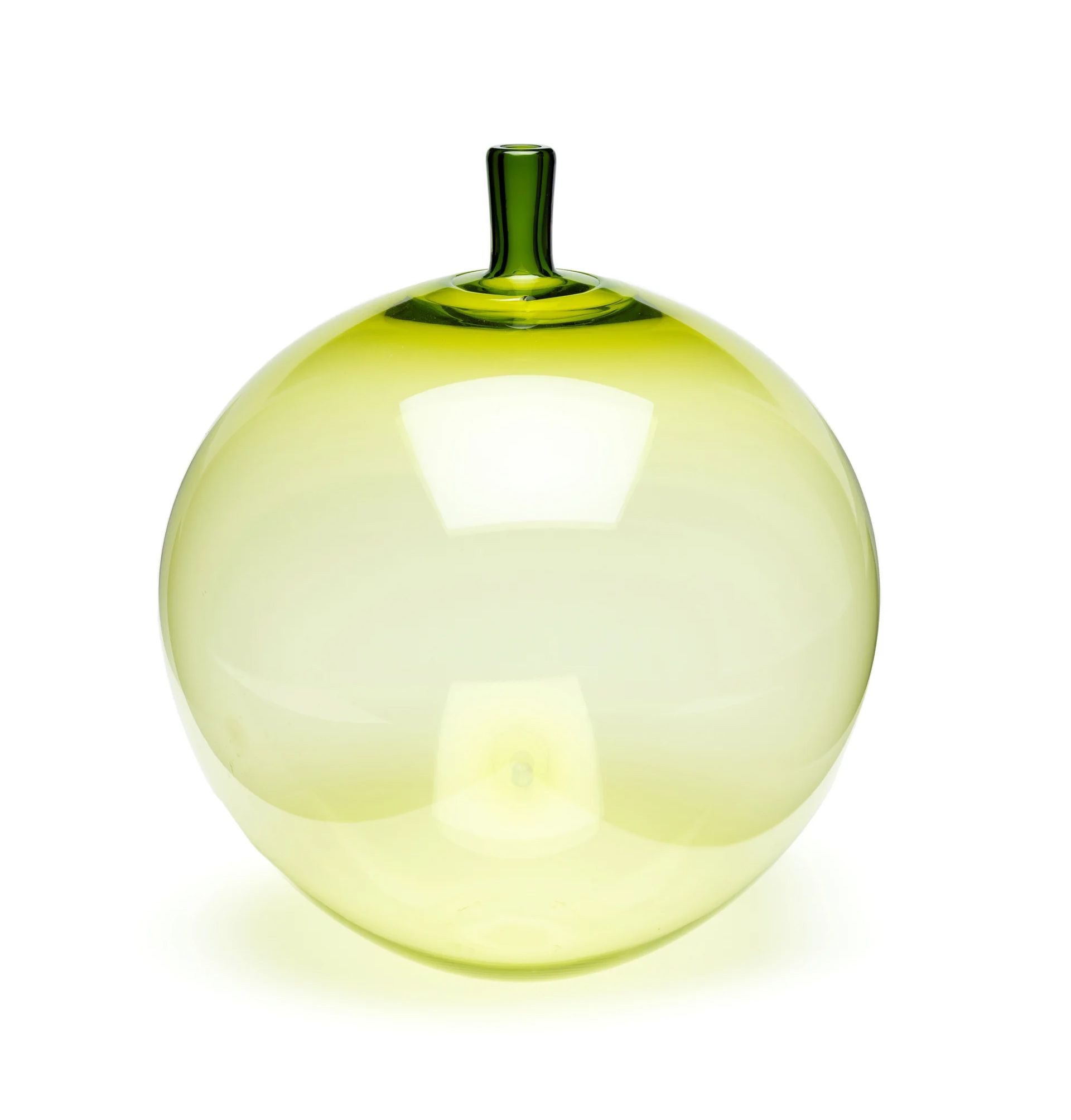 A green, glass blown, apple-shaped vase.