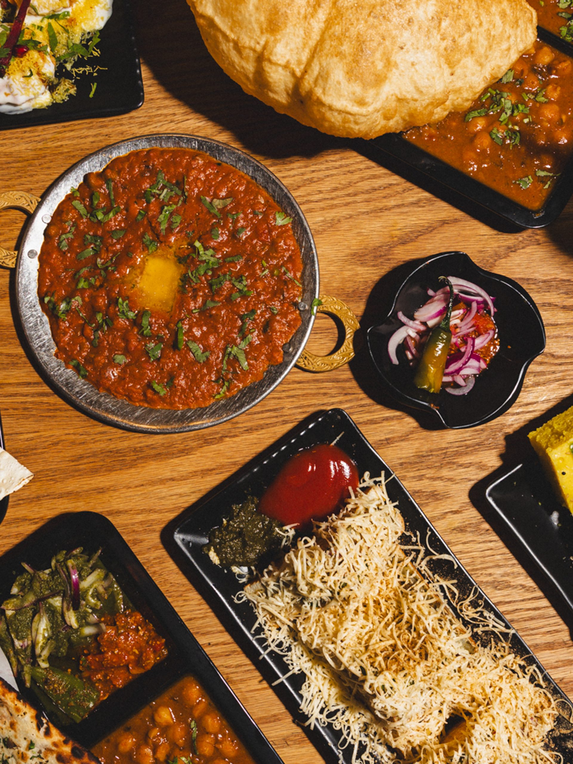 Tabled filled with plates of food.