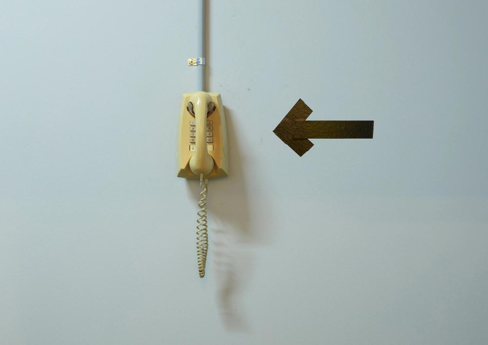 An old phone hangs on a wall