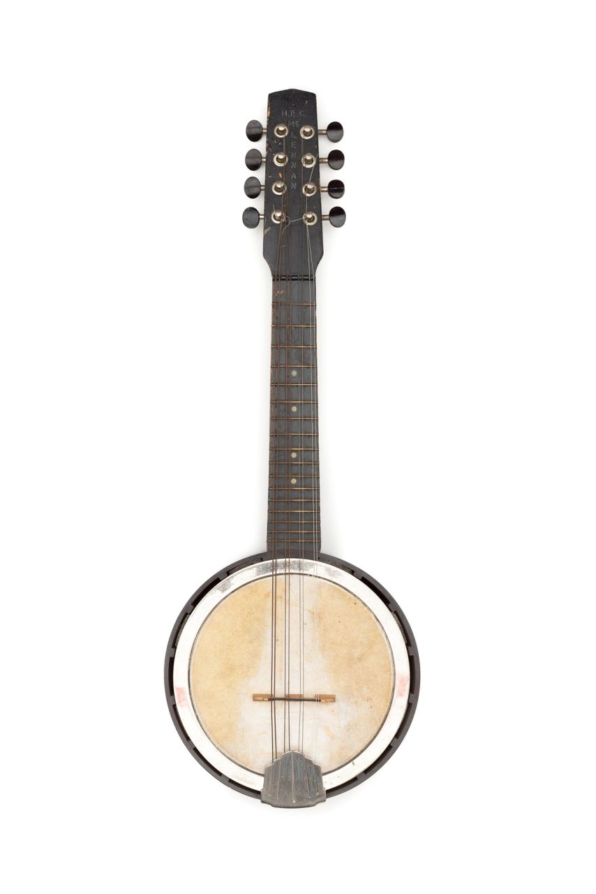 Banjo mandolin consisting of timber headstock and neck of black painted wood. Headstock has eight metal tuning machines in two blocks of four. Dark brown/black Bakelite tuning knobs. Neck has 17 frets. The name "H.E.C. Mc.LENNAN" is stencilled down centre front of headstock.