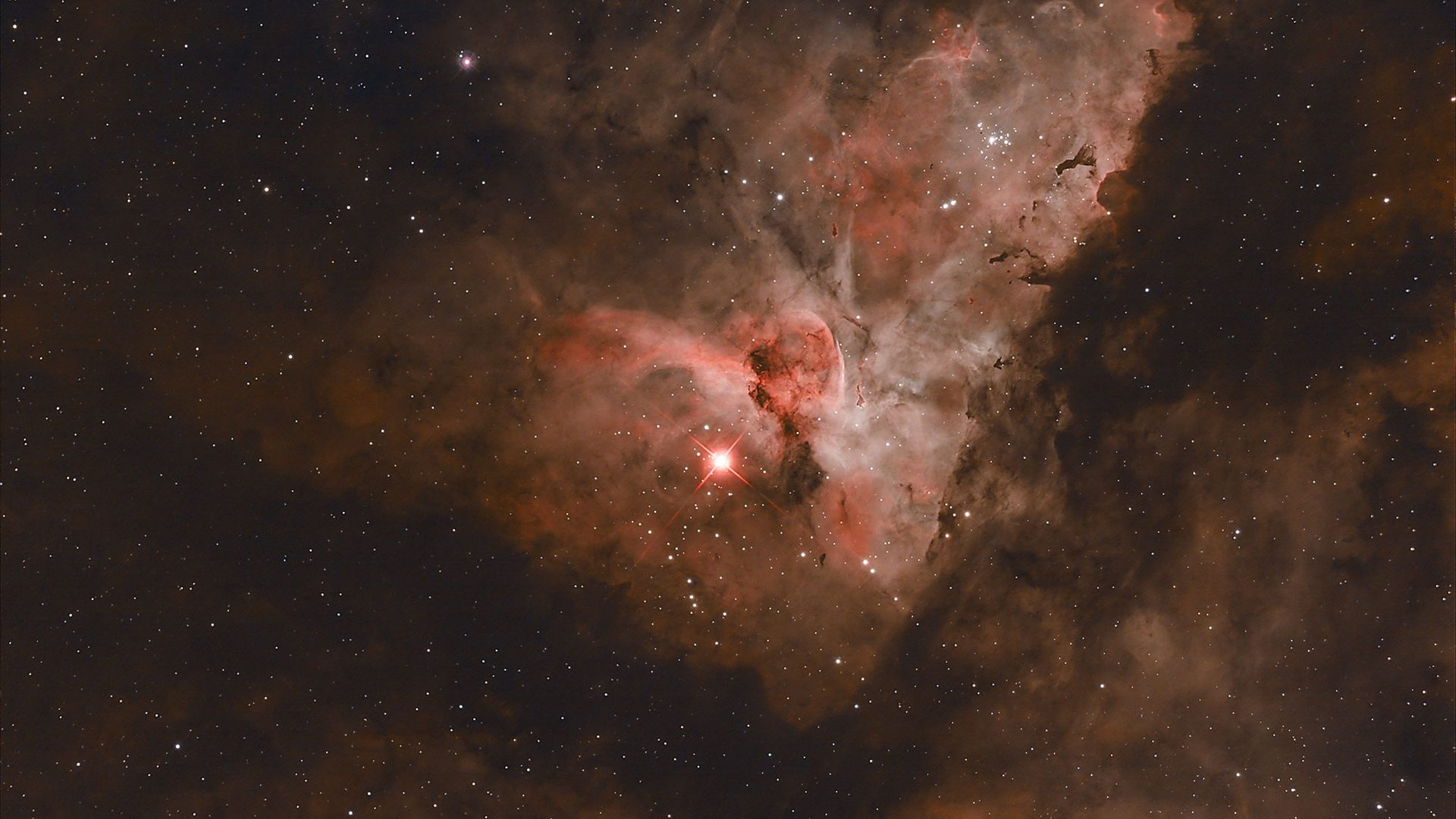 The night sky showing a Carina Nebula also known as a fine star cloud showing as red glow