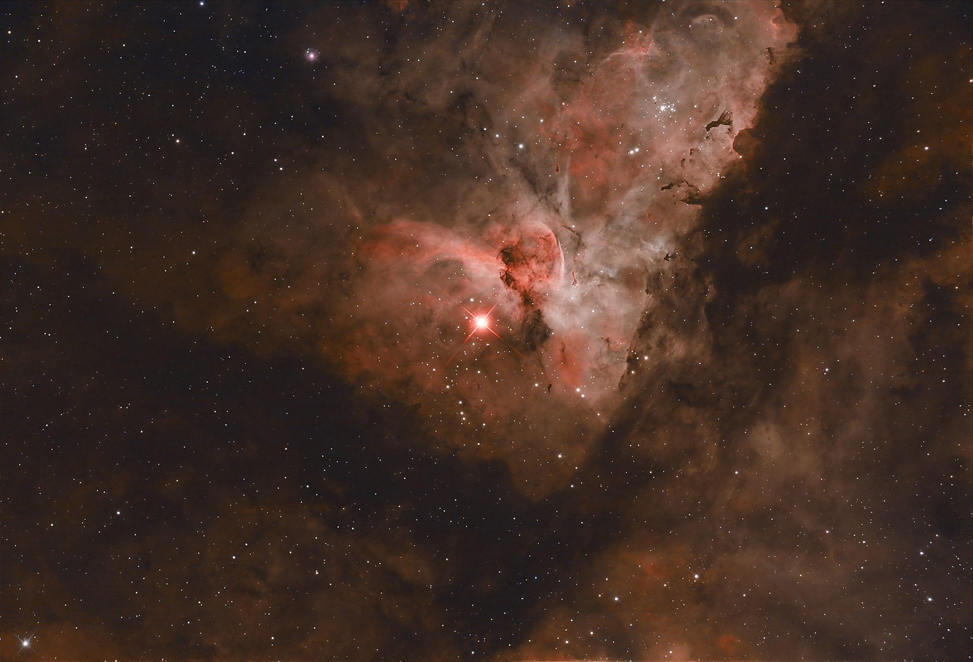 The night sky showing a Carina Nebula also known as a fine star cloud showing as red glow