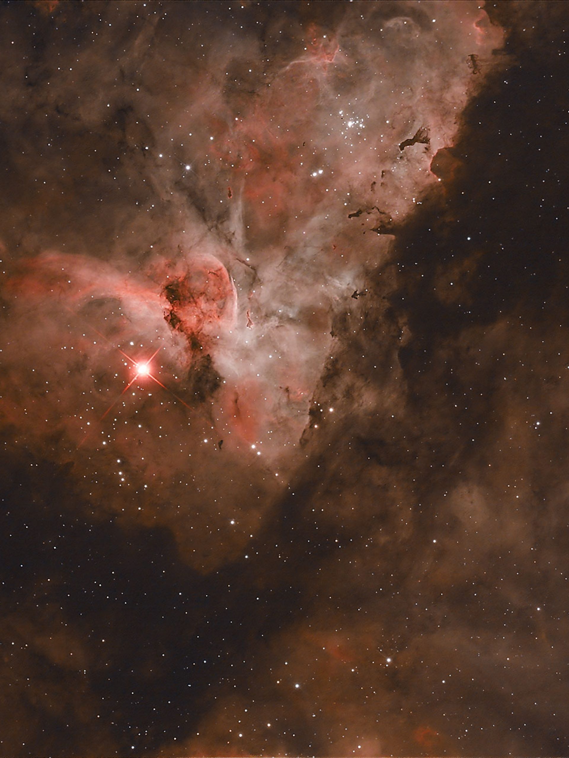 The night sky showing a Carina Nebula also known as a fine star cloud showing as red glow