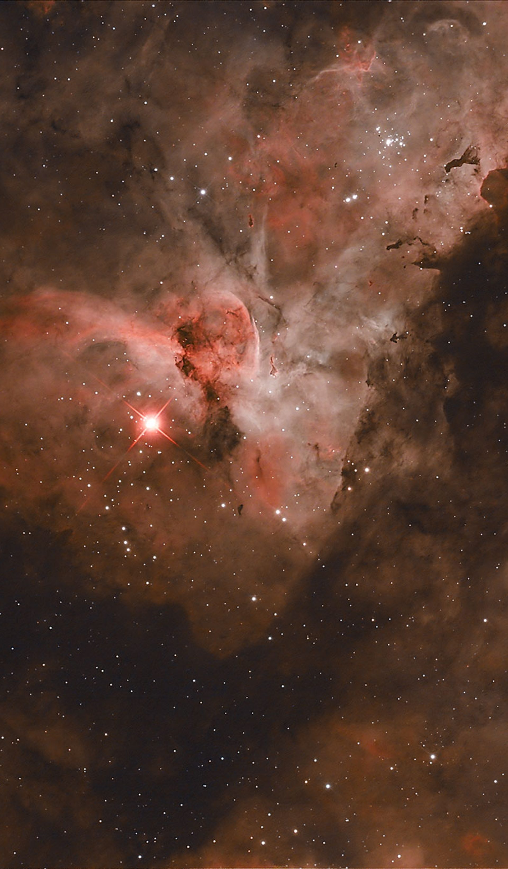 The night sky showing a Carina Nebula also known as a fine star cloud showing as red glow