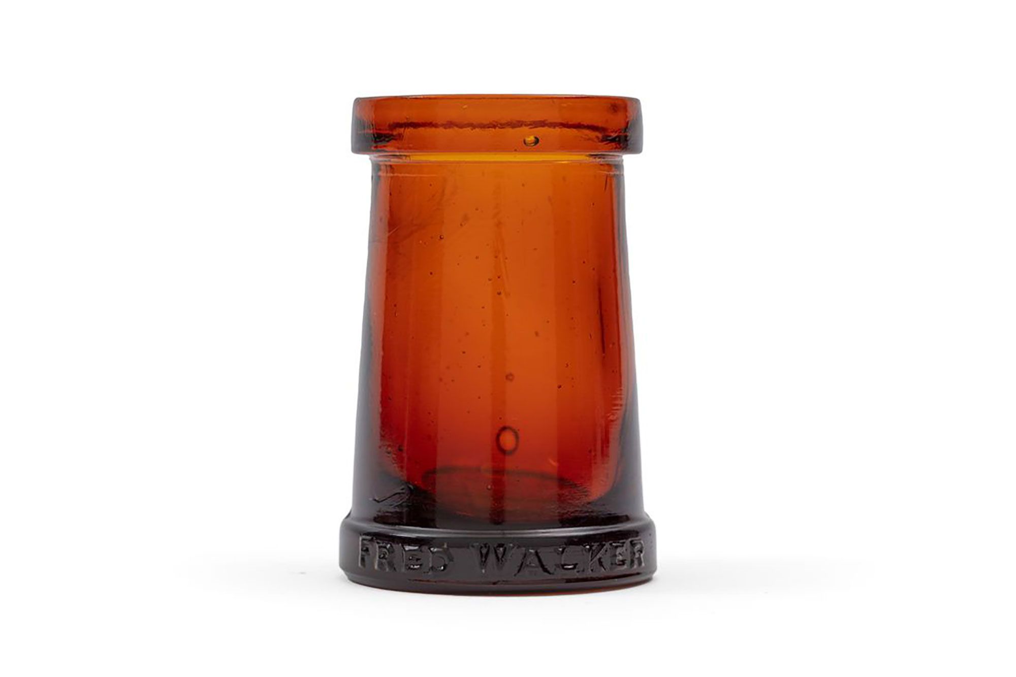 Amber coloured glass jar, cylindrical in form slightly tapering in at the neck from the base. The jar is both lipped and footed. The jar is missing the lid and the label.